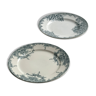 Pair of old decorative earthenware plates with green floral patterns.