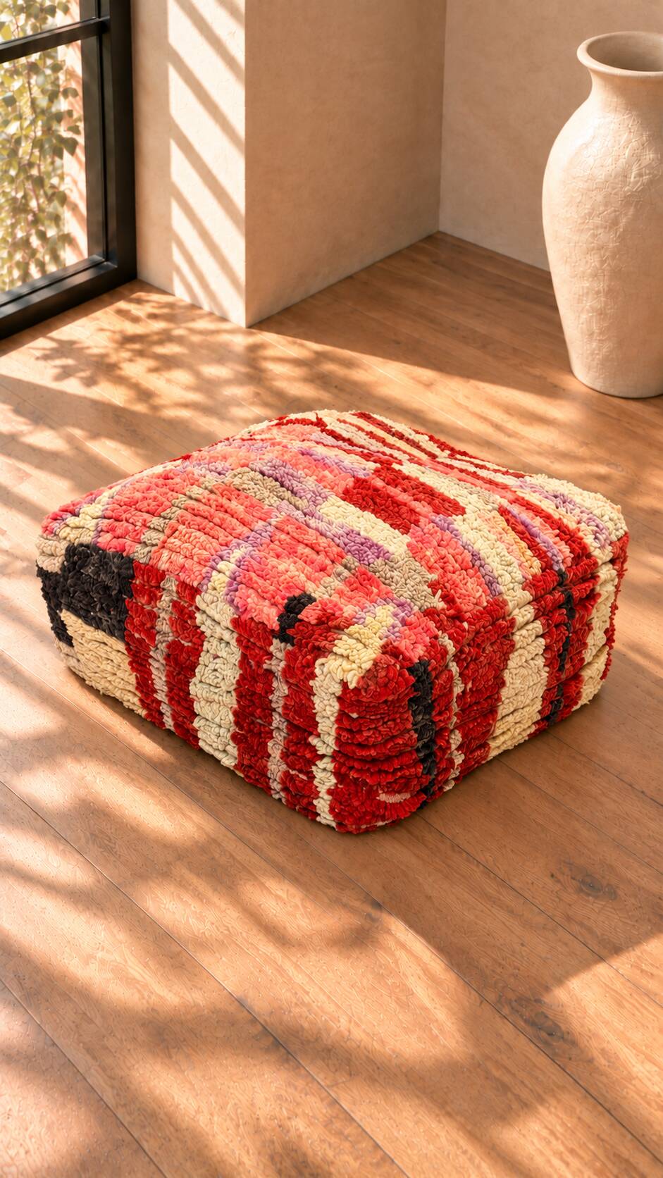 Vintage Moroccan pouf in multicoloured handmade wool.