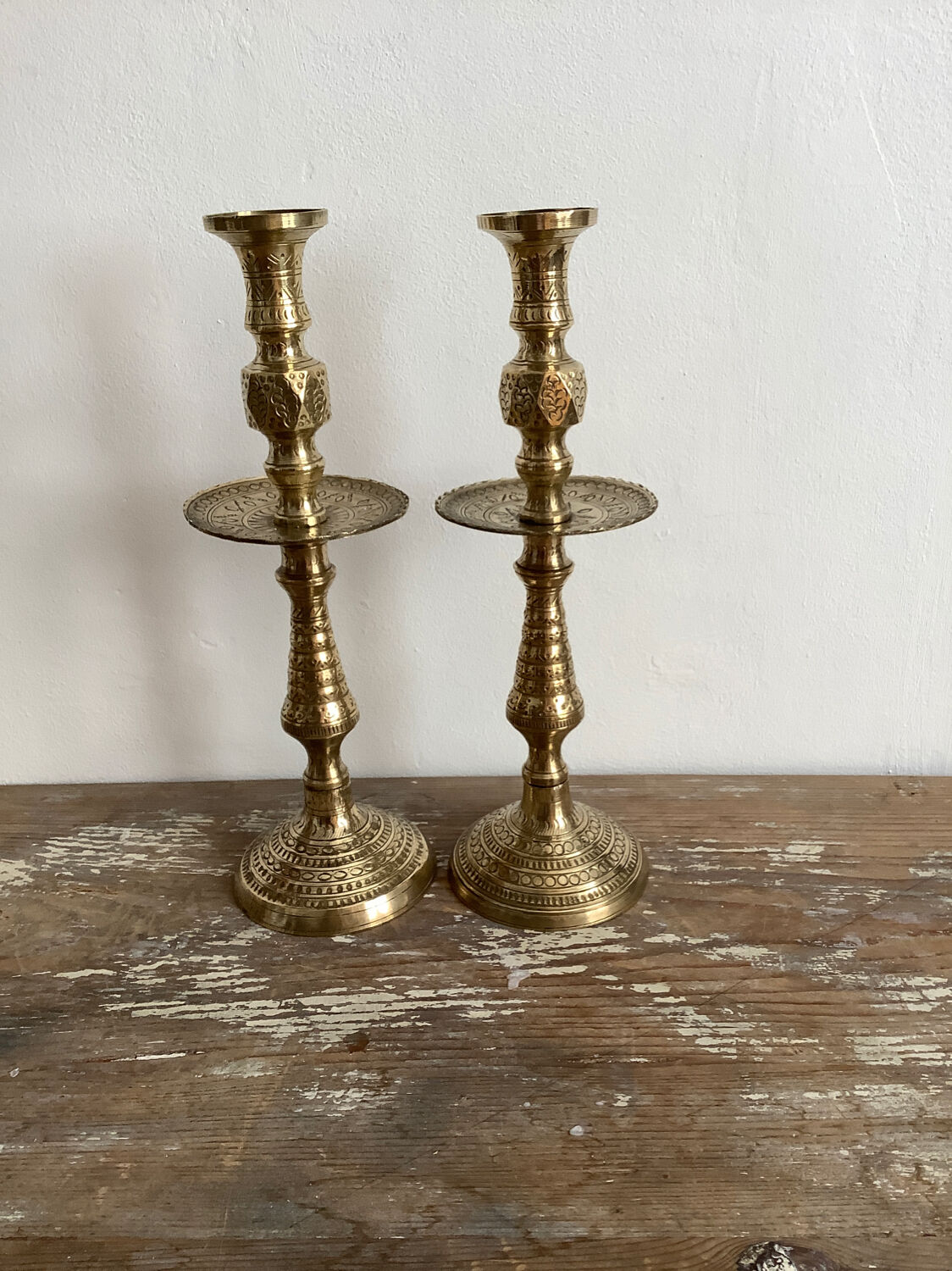 Pair of engraved brass candle holders