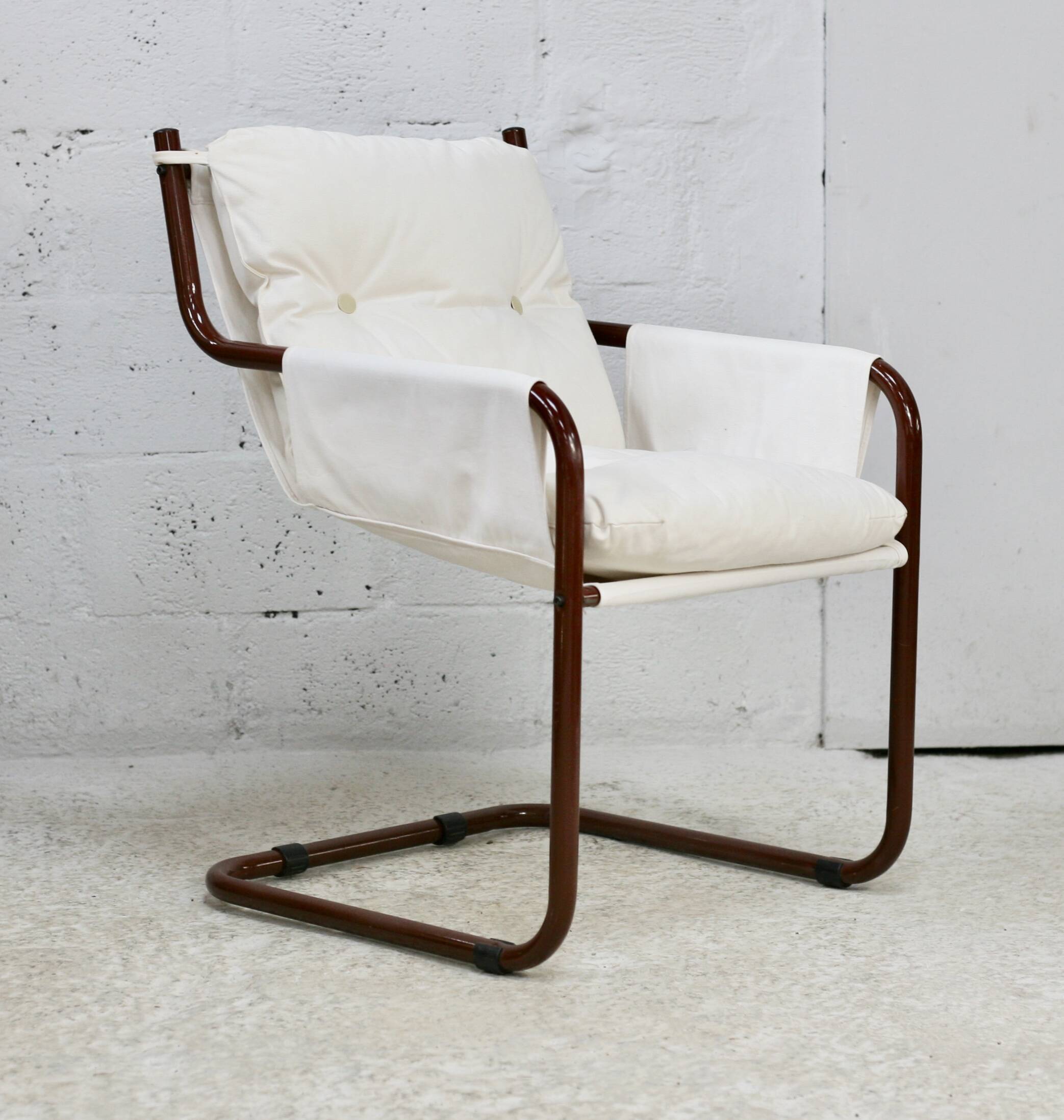 Tubular armchair, fabric suspended seat. Circa 1970