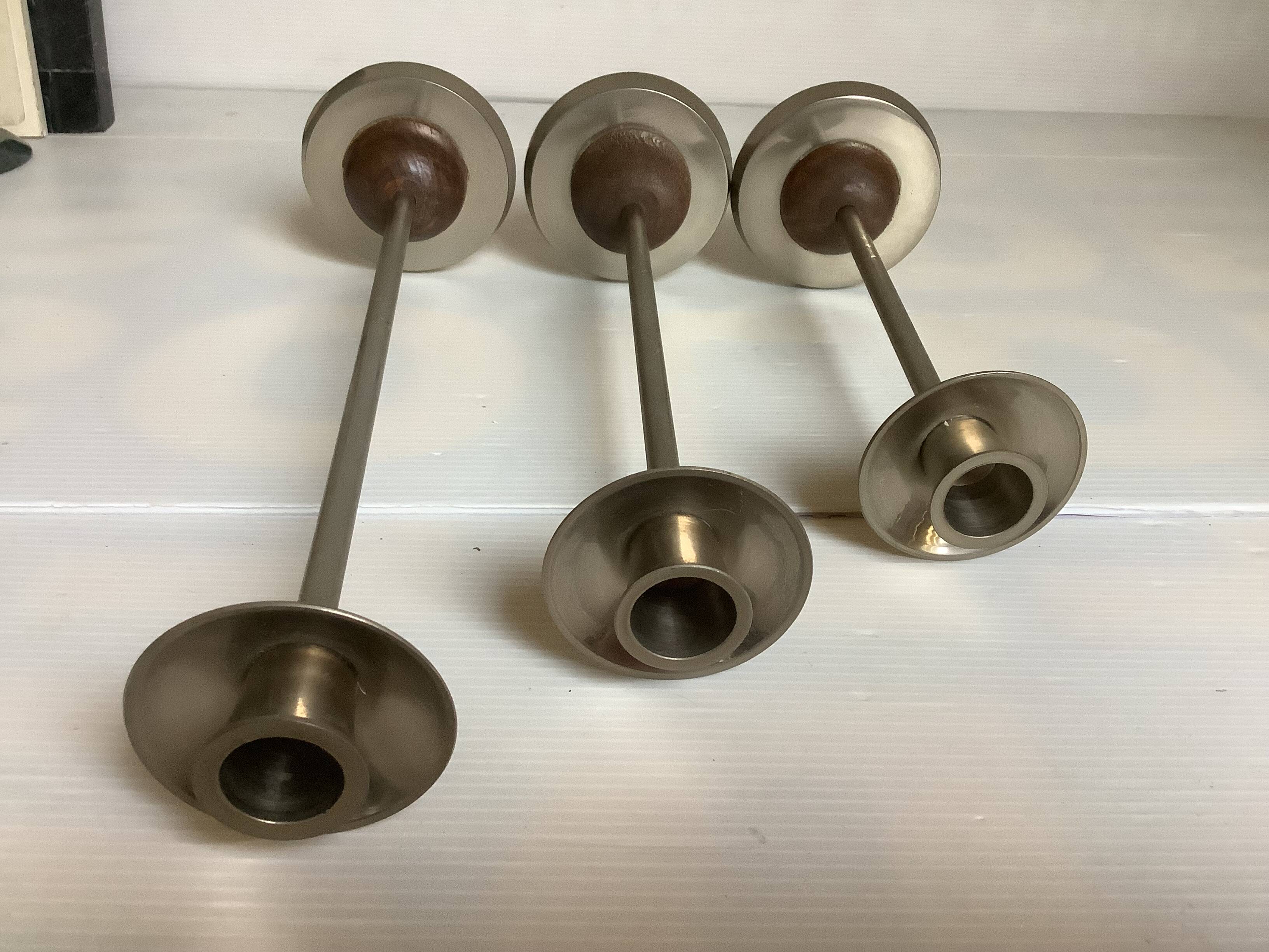 Trio of metal and wood candlesticks
