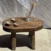 Small stool, oval solid teak side table with curved legs in wabi-sabi style.