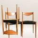 Set of 6 modernist chairs with black faux leather seats.