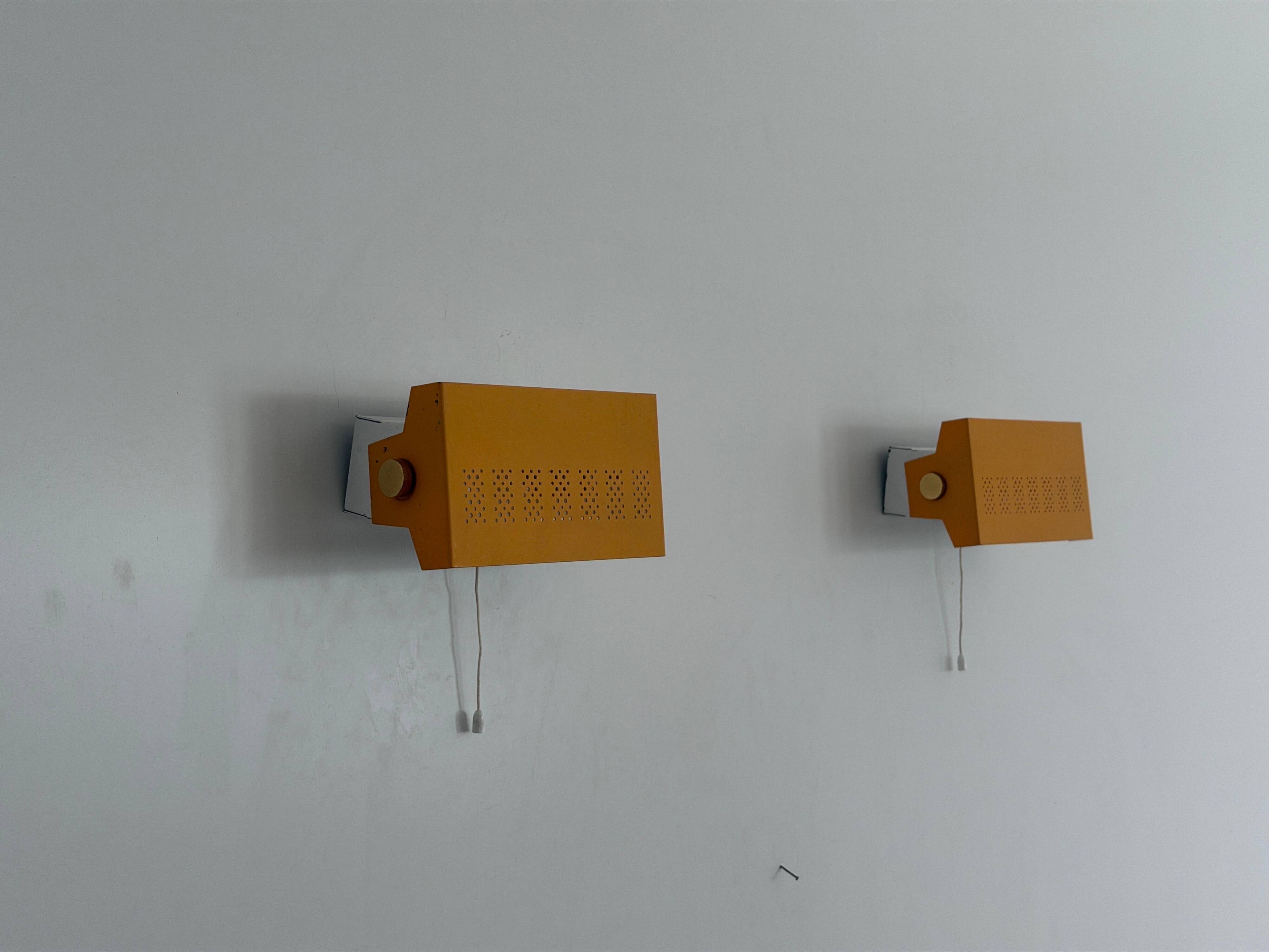 Pair of yellow metal wall lights from the mid-century by N Leuchten, 1960s, Germany.