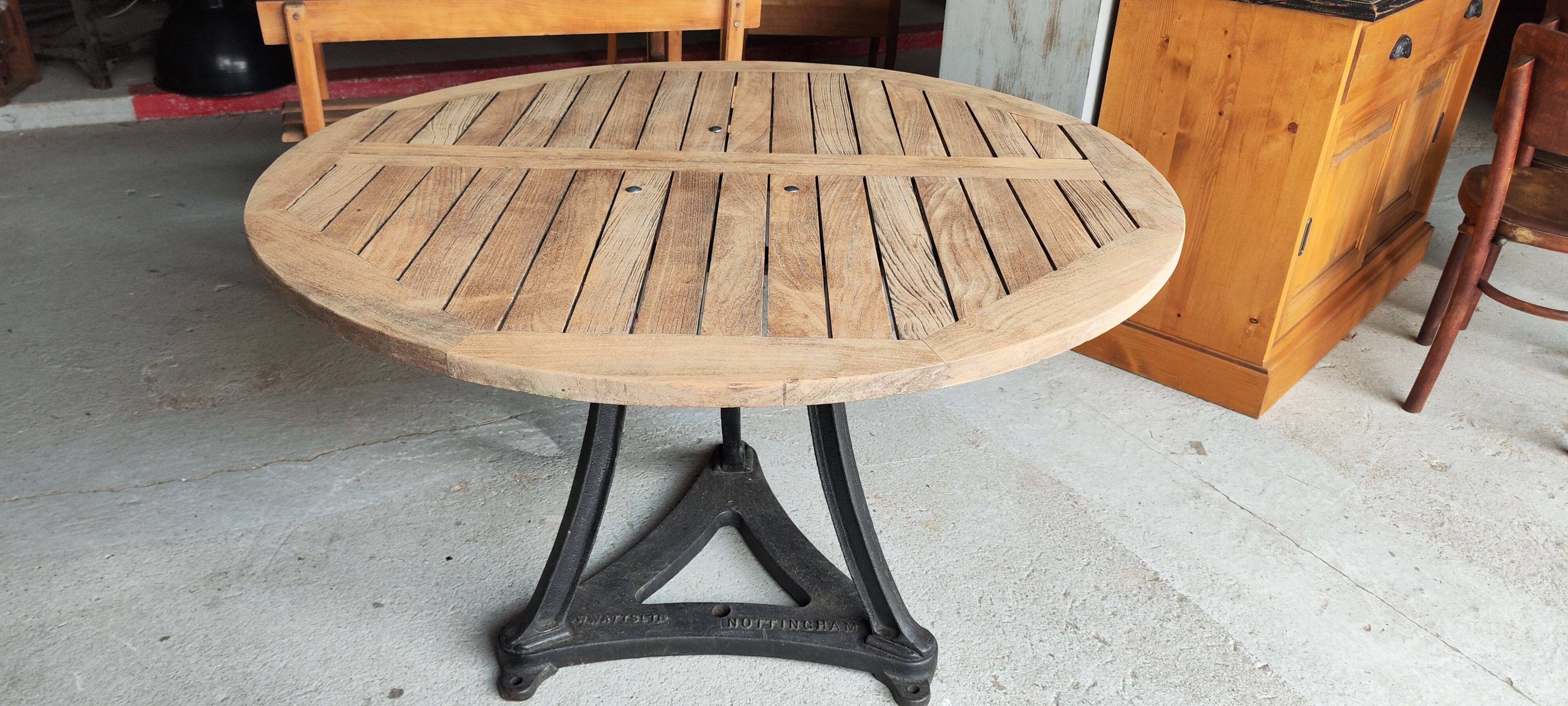 Industrial table with cast iron legs and teak top