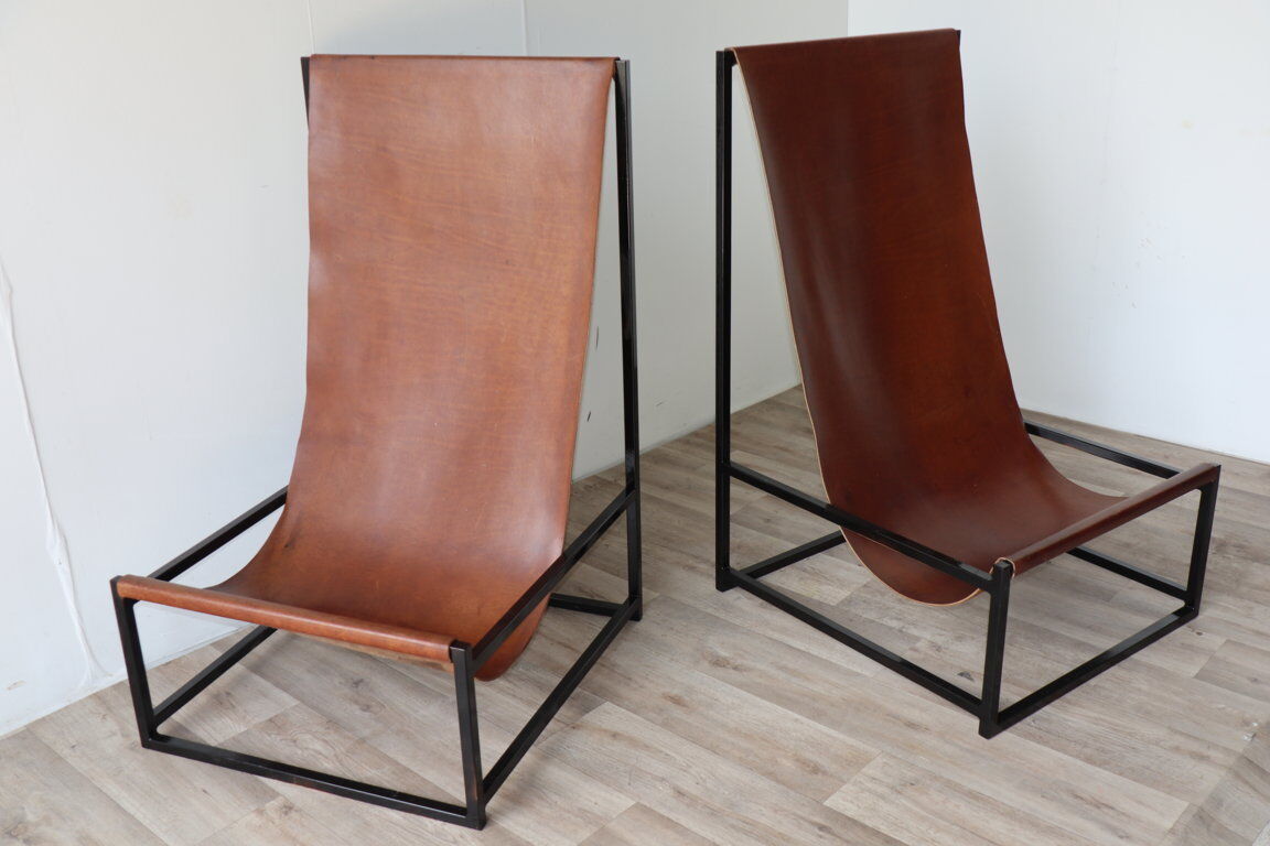 Pair of vintage armchairs in stretched leather and metal structure