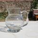 Vintage blown glass pitcher with bubbles, transparent.