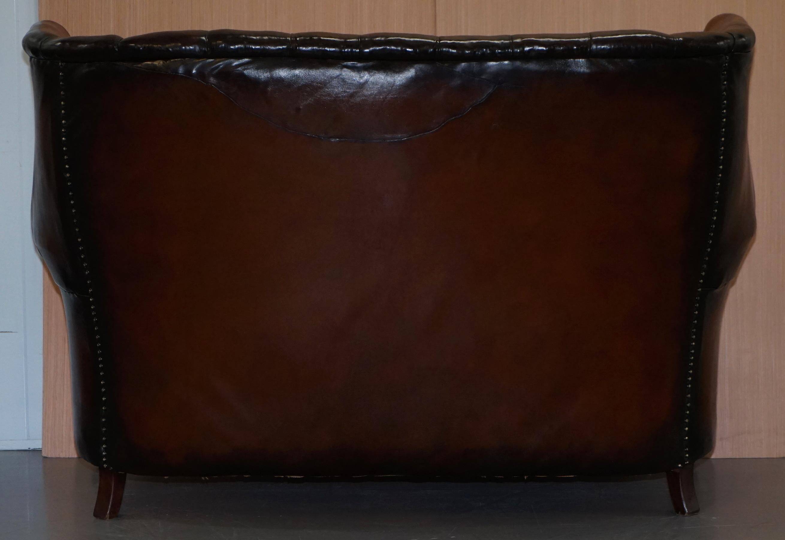 Victorian leather canapé and armchair, barrel back, circa 1860, restored.