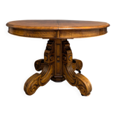 Guéridon, table extensible à pied central en noyer sculpté