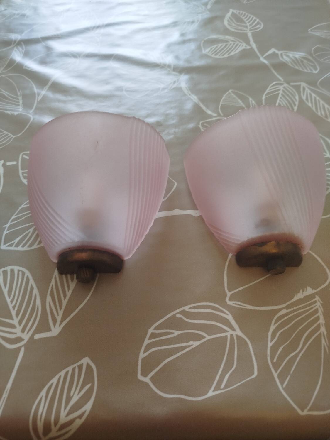 Art Deco wall lights with frosted pink glass and brass.