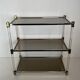 Lucite Shelf with Three Smoked Glass Shelves and Brass Ends. Work