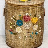 Vintage wicker mannequin with colourful floral decoration.