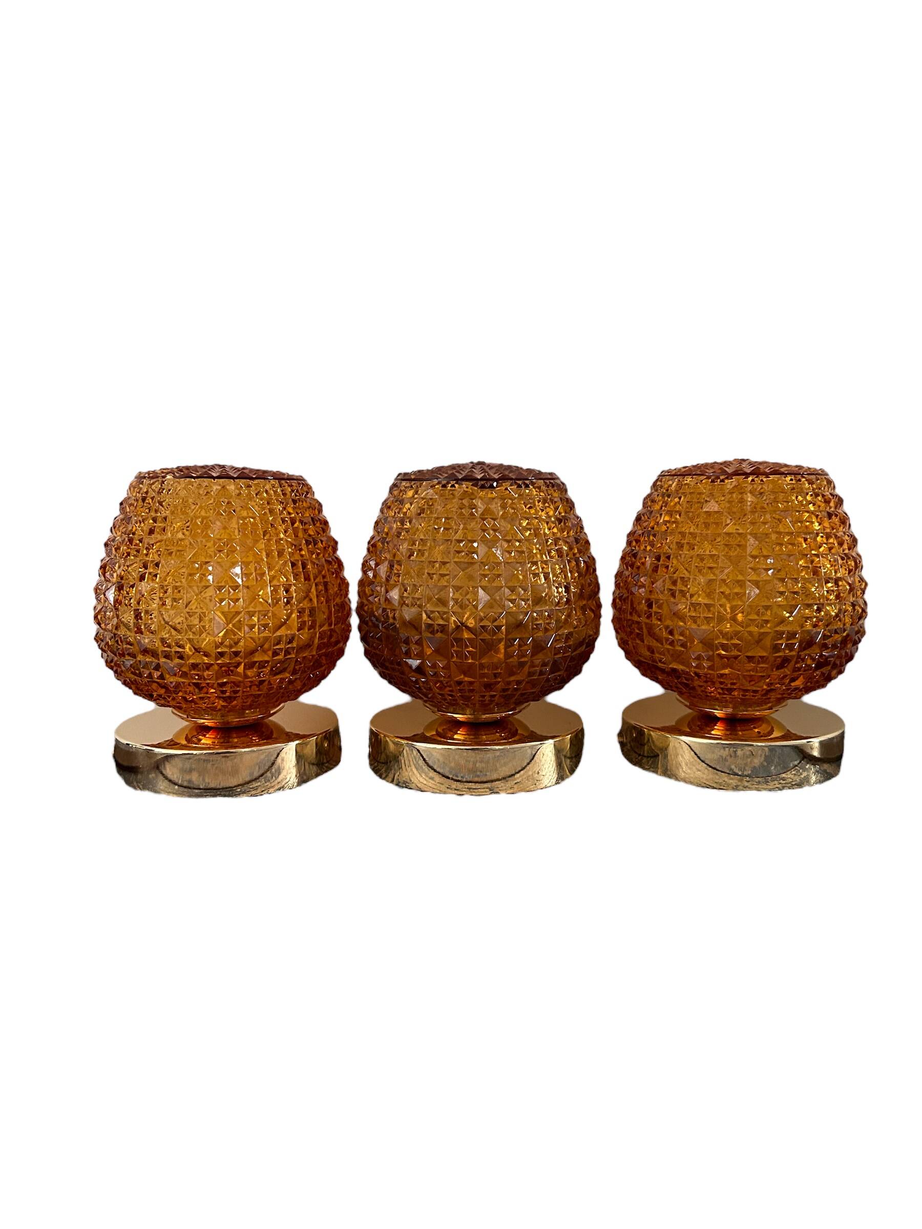 Set of three vintage wall or ceiling lights in amber chiseled glass
