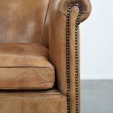 Characterful club chair made of sheepskin leather with light cognac colours