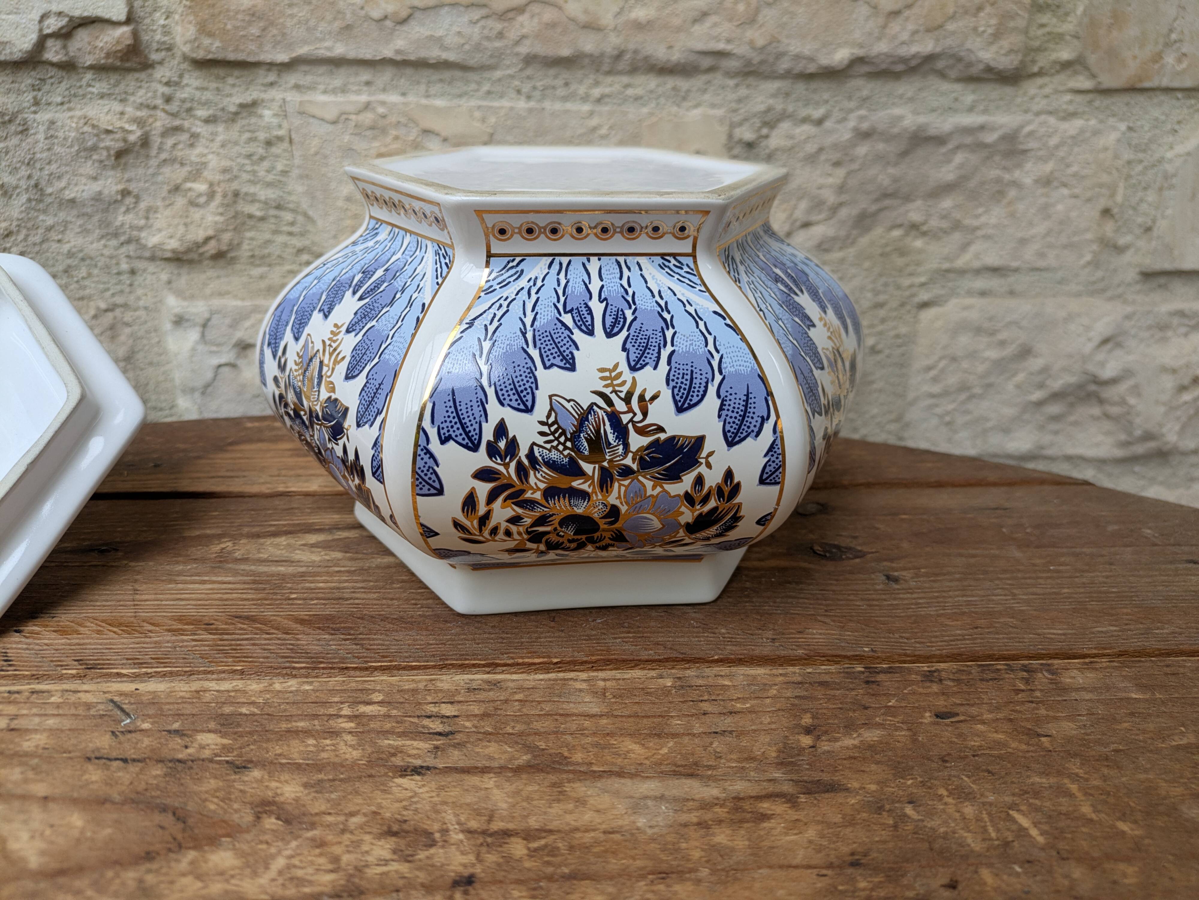 Decorative pot jar with a lid featuring a blue floral pattern and gilding.