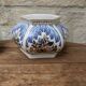 Decorative pot jar with a lid featuring a blue floral pattern and gilding.