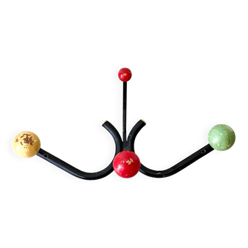 Vintage metal and wood coat rack in yellow/red/green.