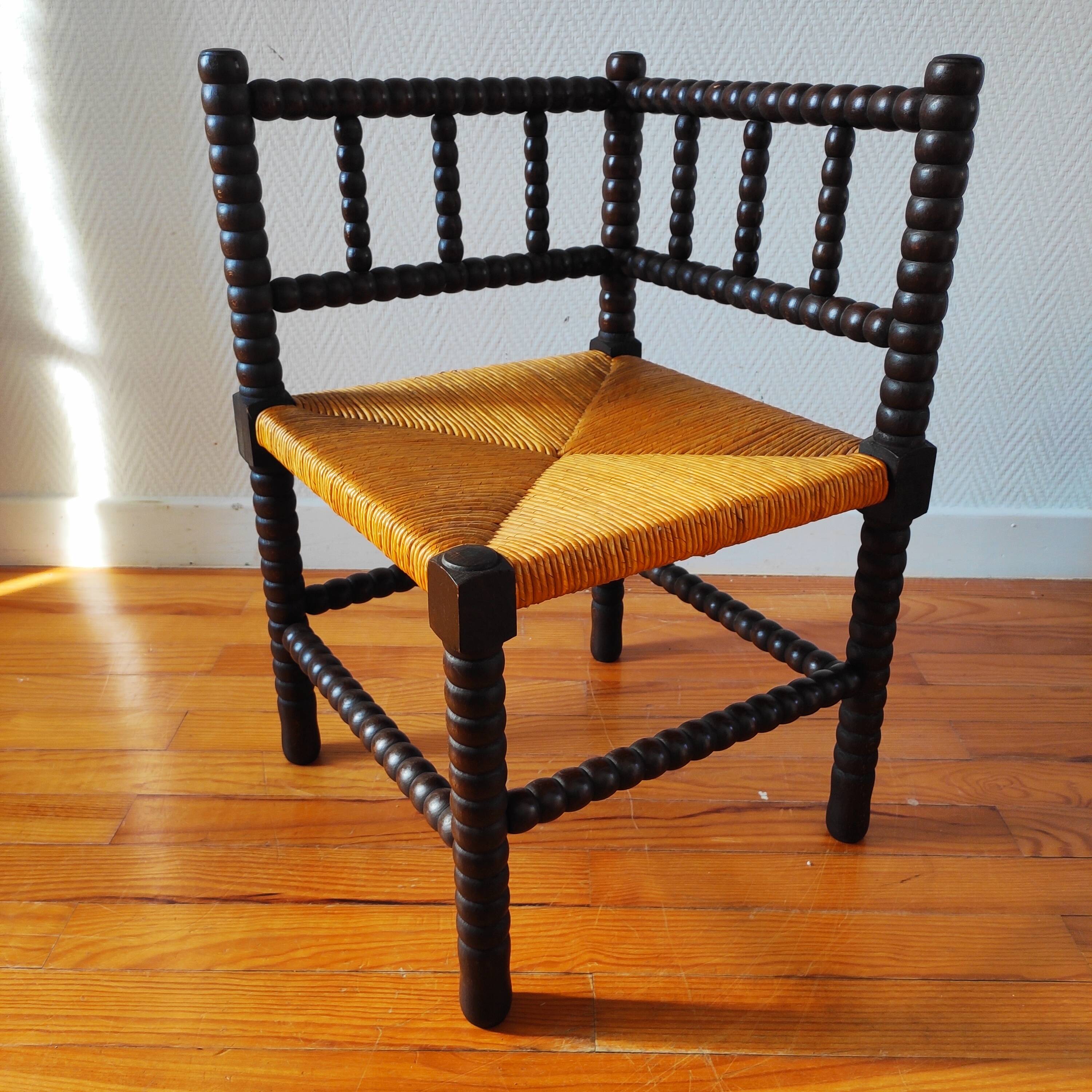 Antique corner chair made of turned wood.
