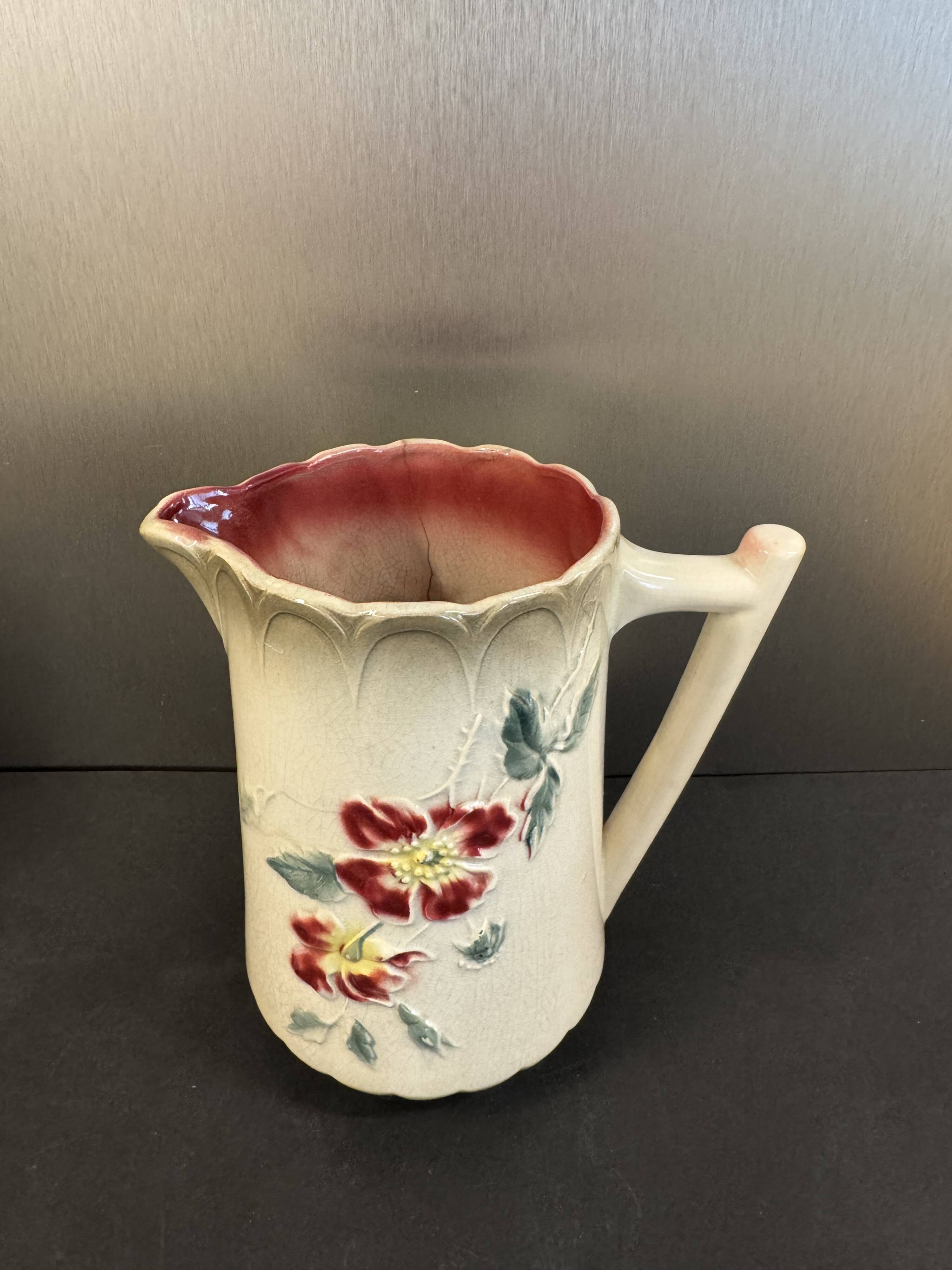 Antique pitcher in slipware with floral decoration – red and cream floral design