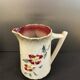 Antique pitcher in slipware with floral decoration – red and cream floral design