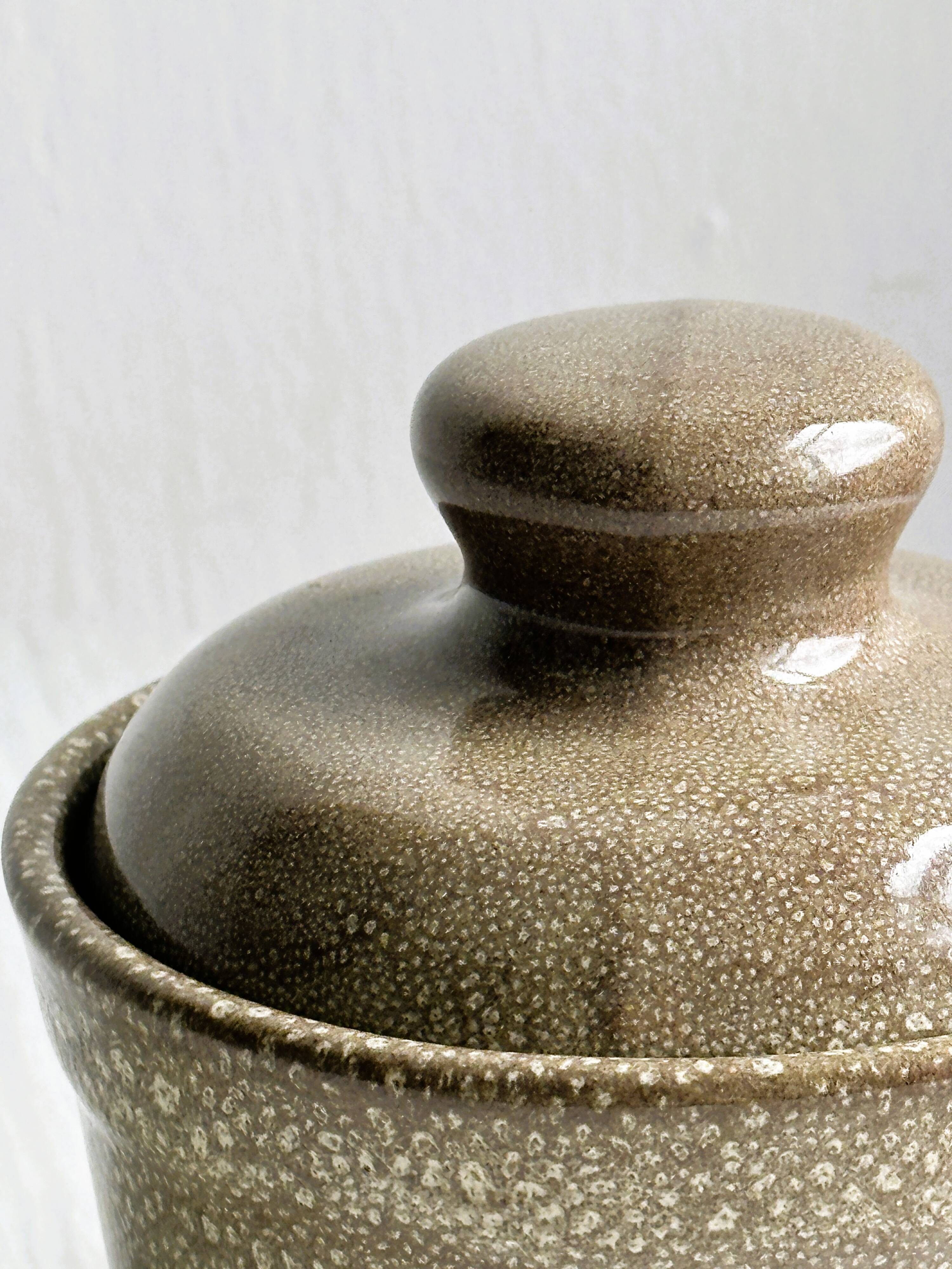 Gray and white speckled ceramic pot.