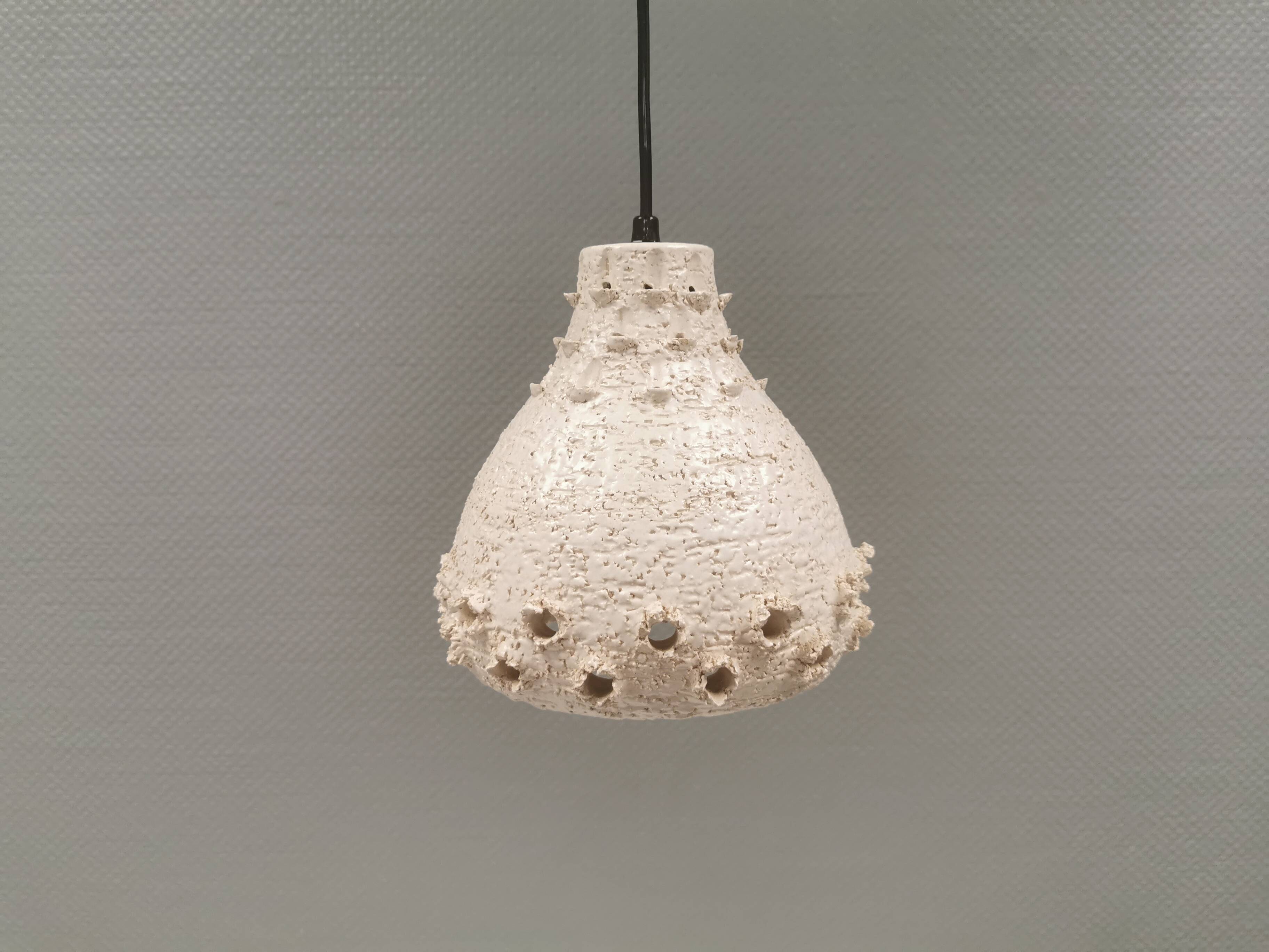 Ceramic hanging lamp in creamy white color that almost looks like a corral