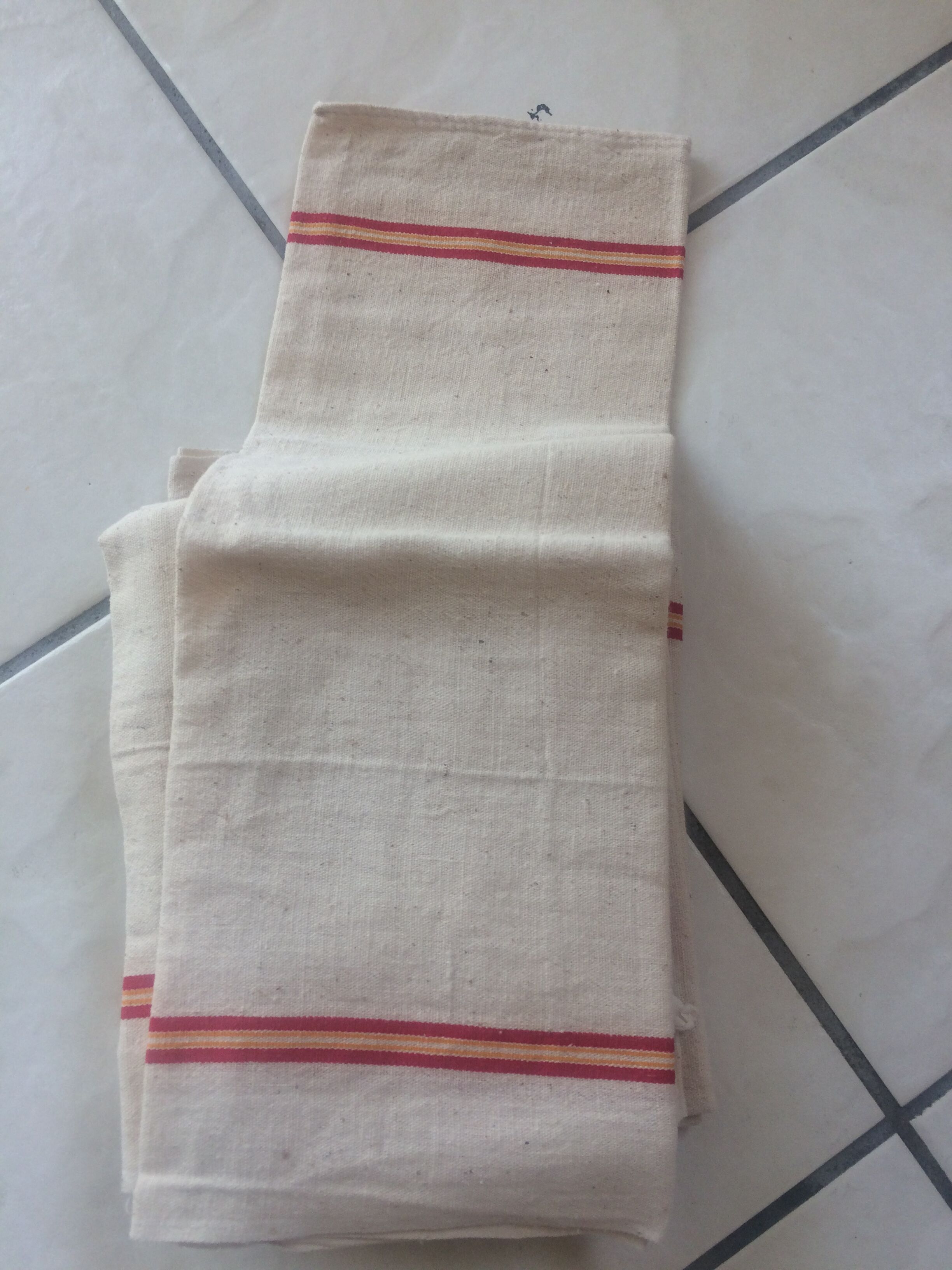 8 off-white towels with thin red and yellow stripes