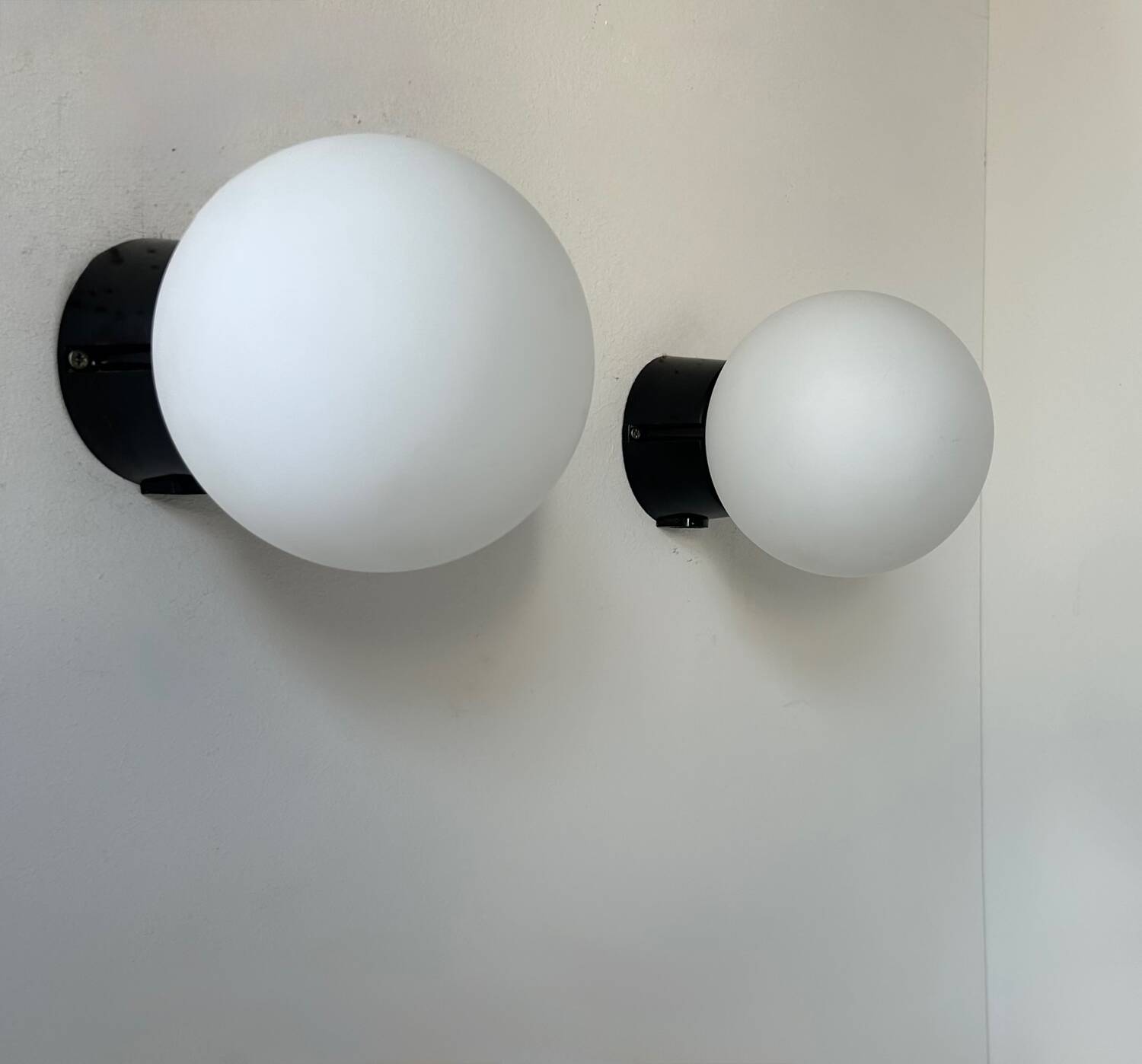 Pair of vintage Raak opaline and Bakelite wall lights, Netherlands 1970s