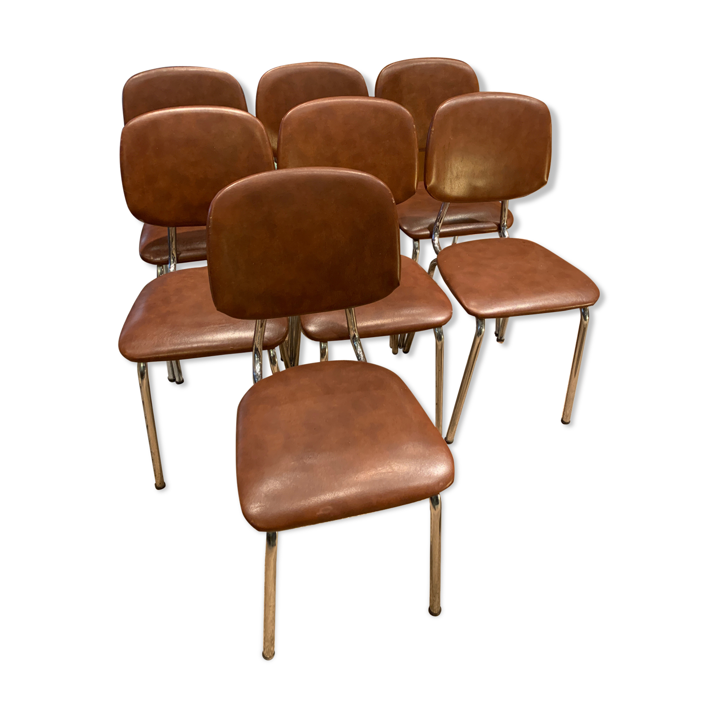 Série de 7 chaises en skaï