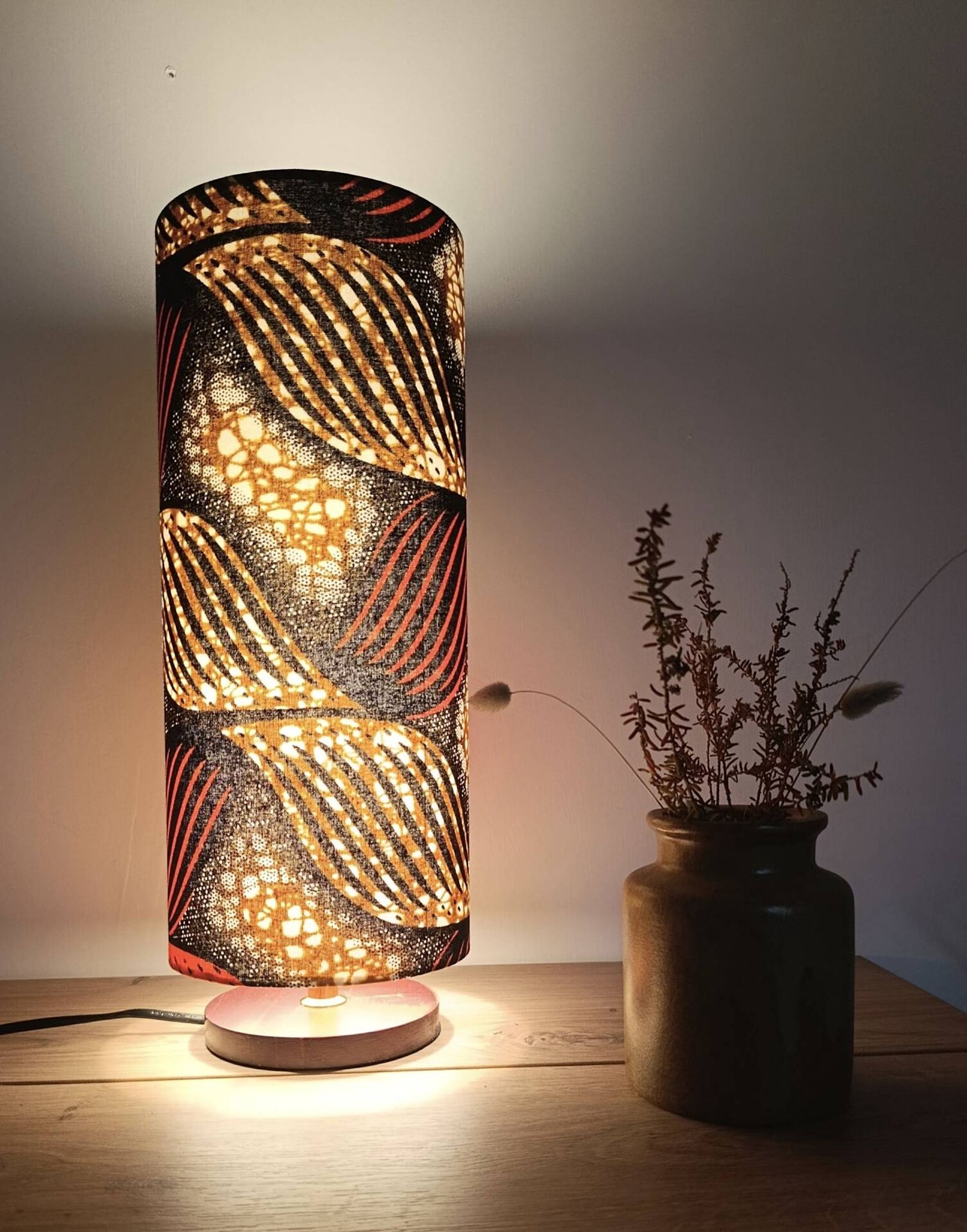 Tube lamp with wooden base and wax boho-ethnic fabric