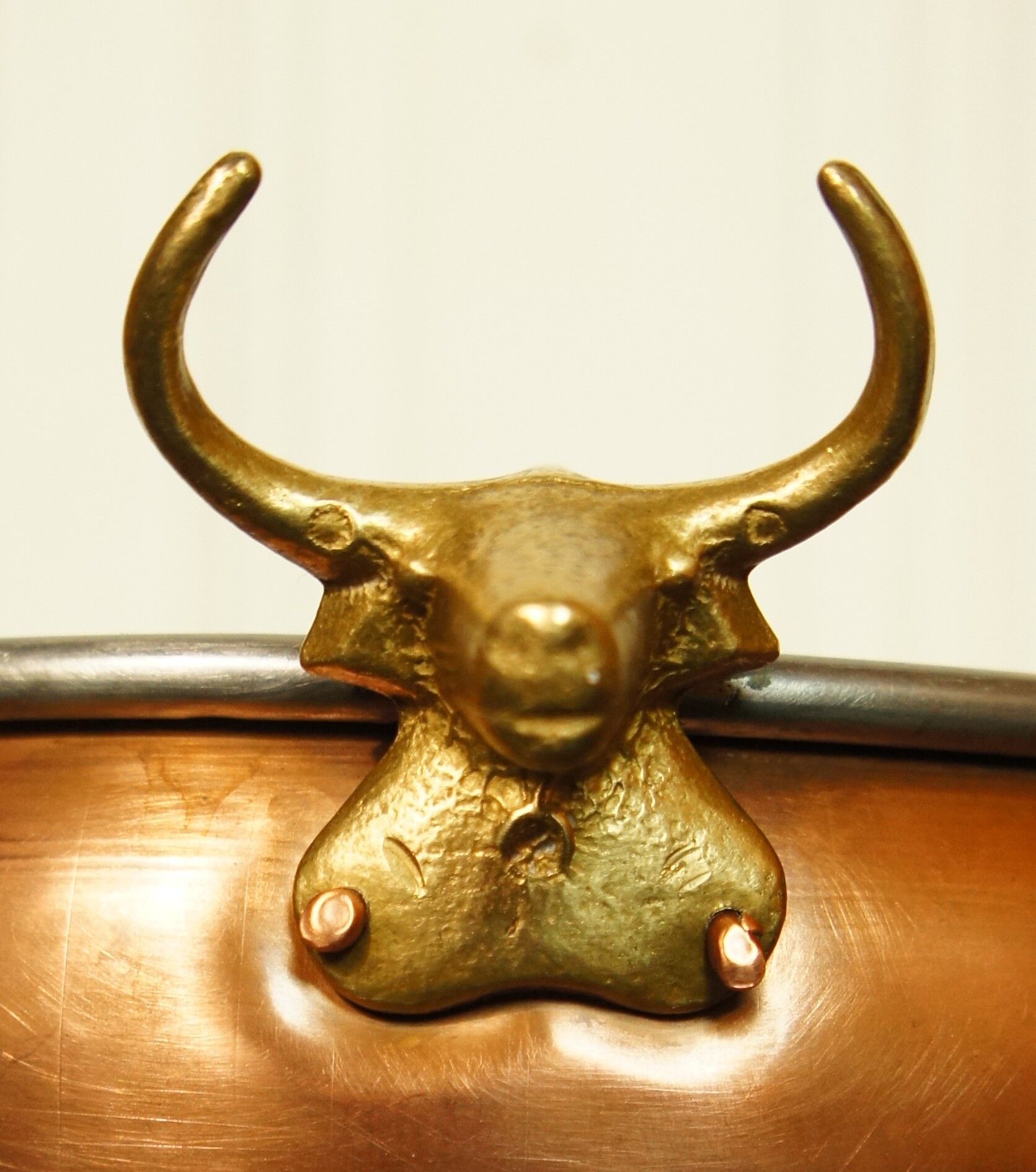 Copper cauldron with golden bronze bull heads