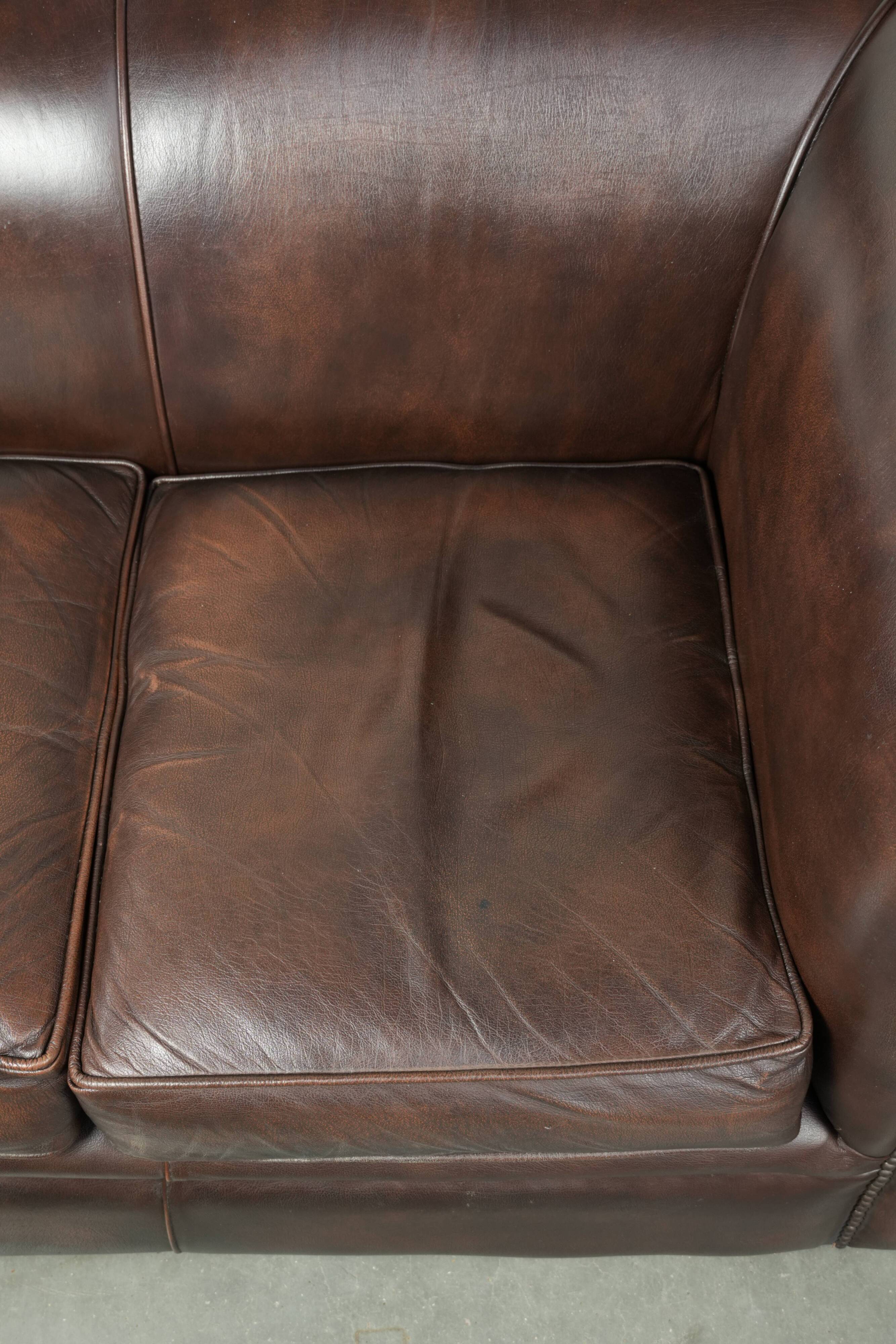 Luxury brown smooth cow leather Chesterfield sofa with an English look