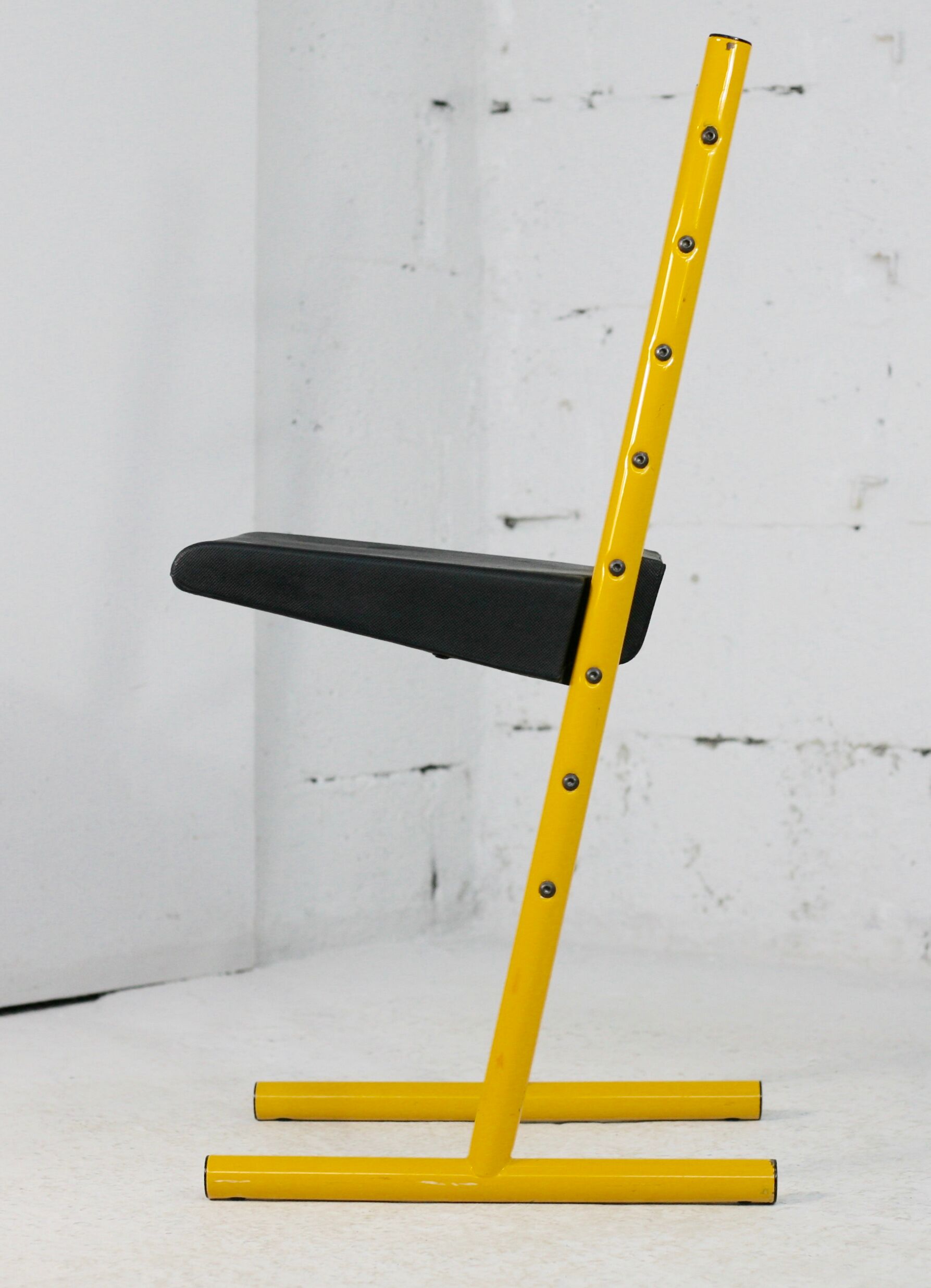 Adjustable seat chair. Circa 1980. Italy. Yellow lacquered steel.
