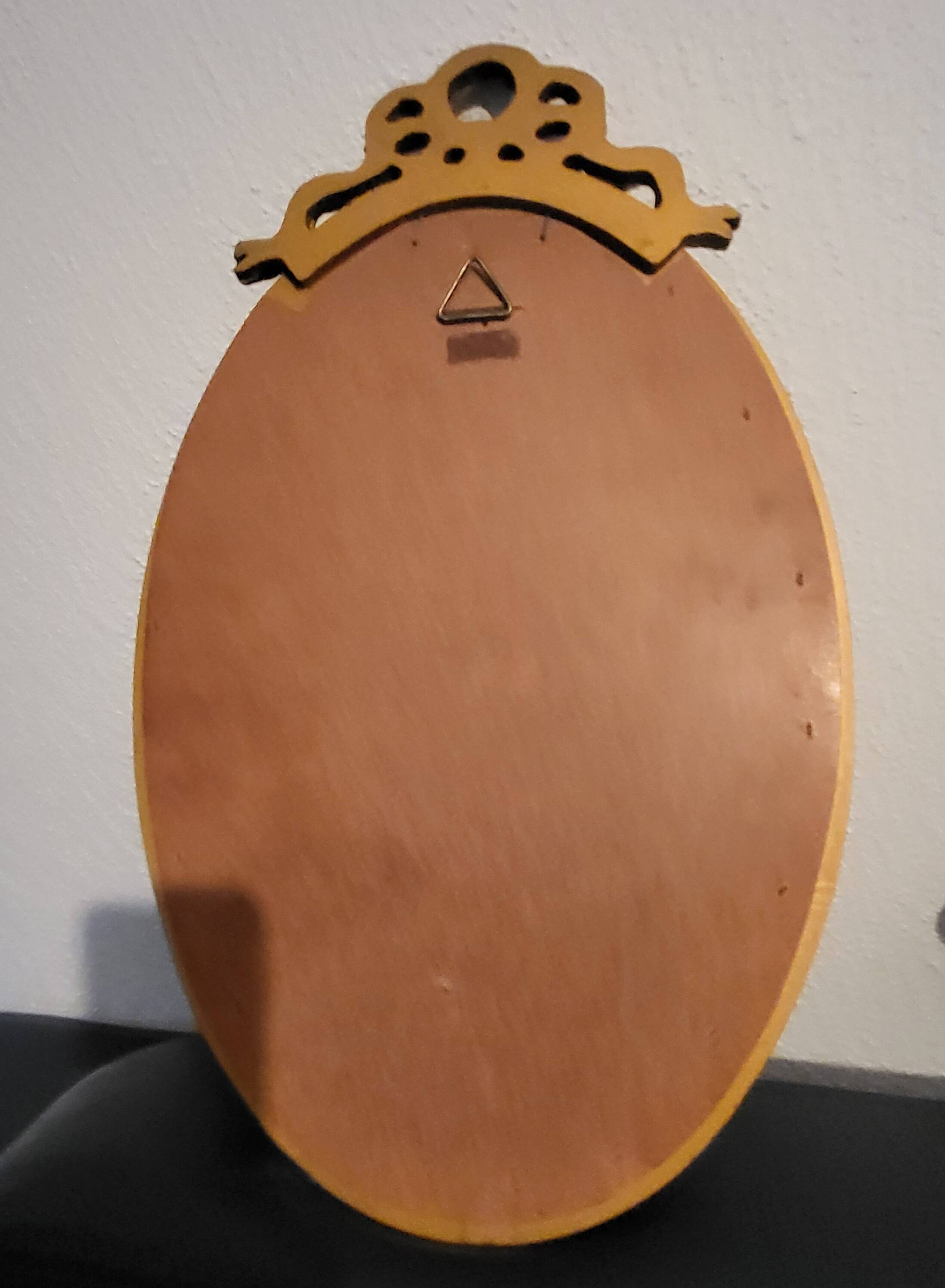 Oval mirror with golden wooden knot