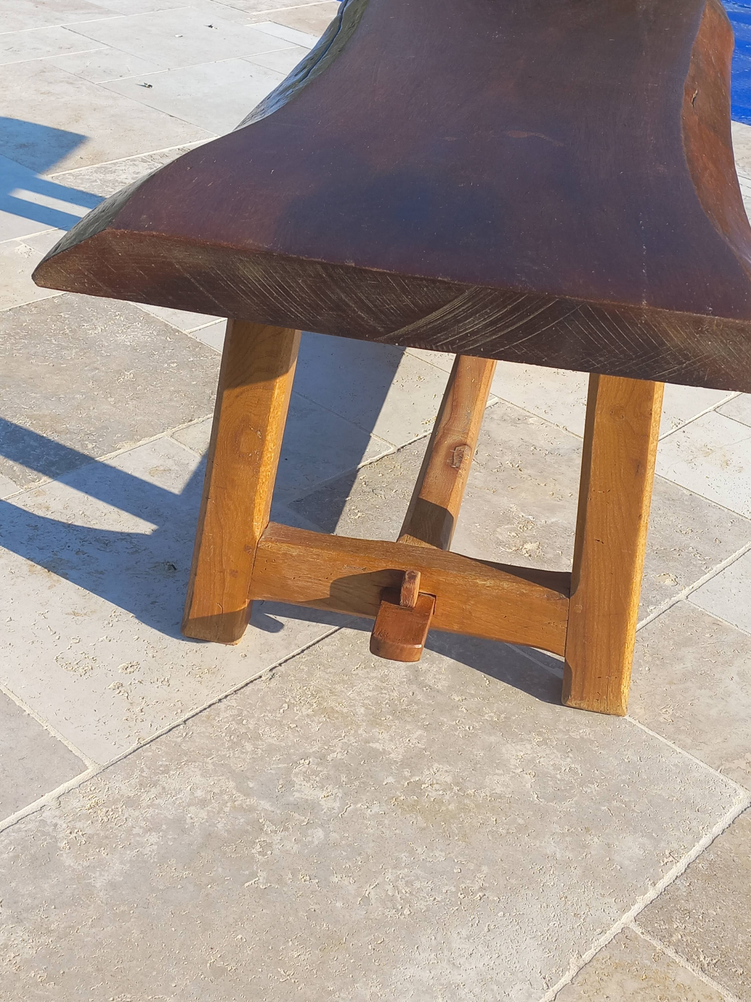 Rustic handcrafted coffee table with a mahogany top and elm legs.