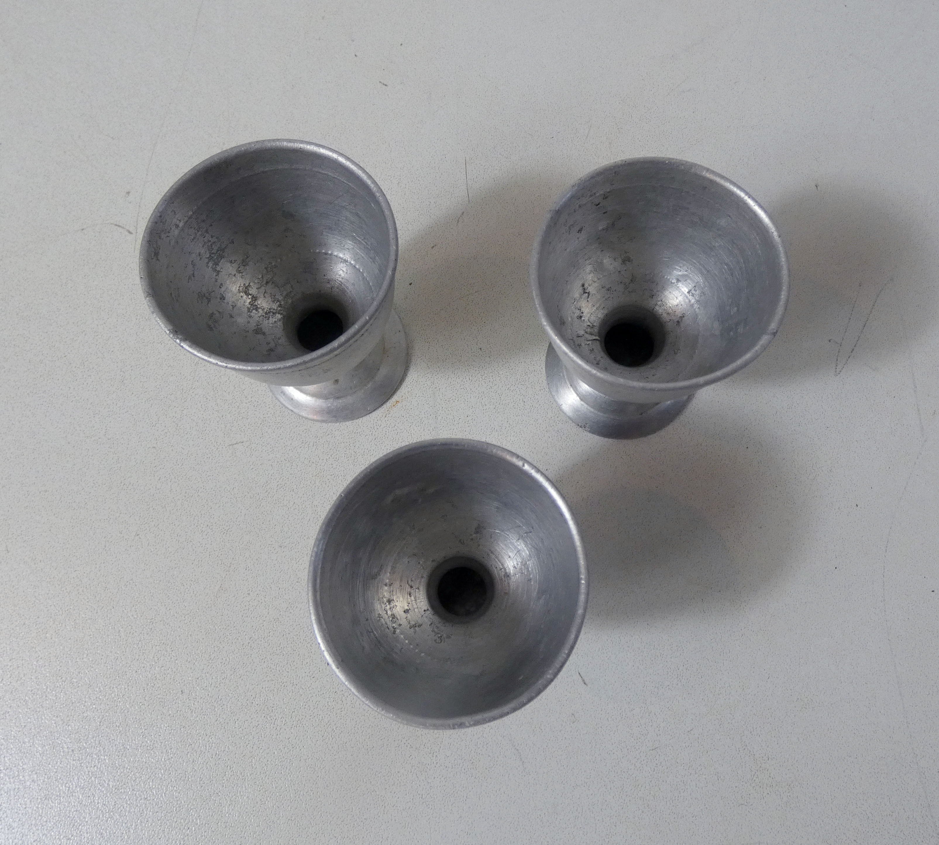 3 old aluminum shells