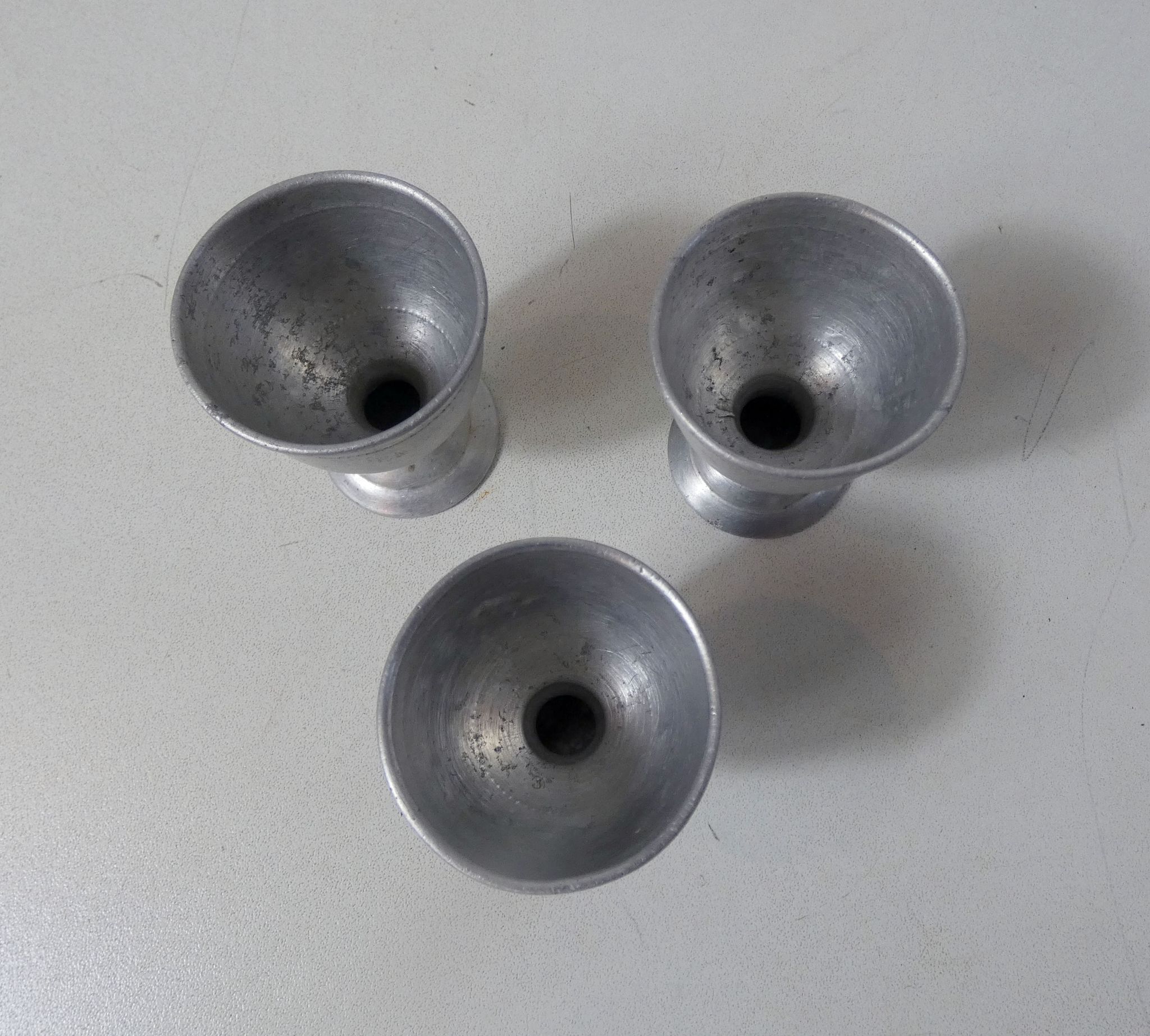 3 old aluminum shells