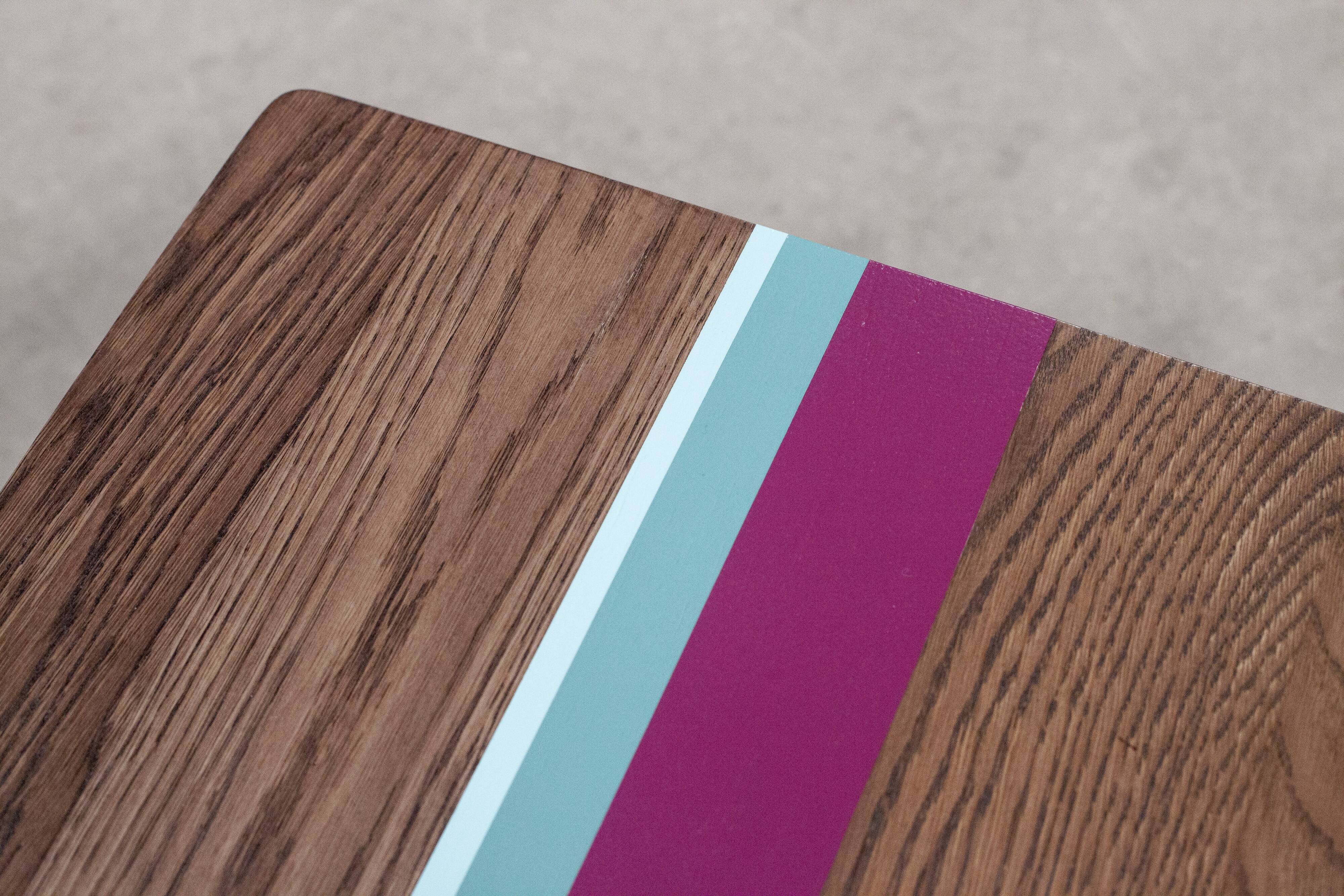 Solid oak coffee table with colored bands on pin legs