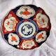 Antique plate in polychrome porcelain IMARI, Japan, red, orange and blue floral decoration.