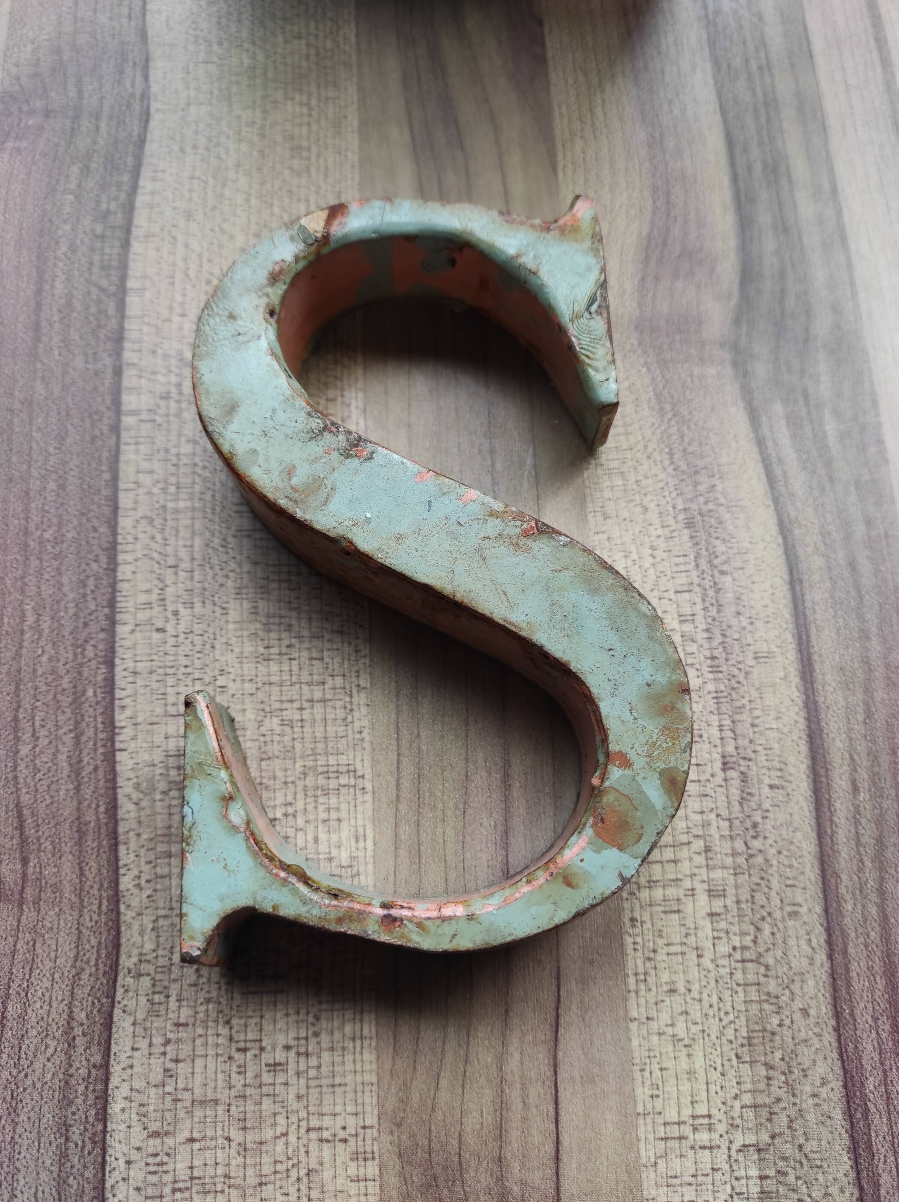 Old sign letter "S" in patinated metal