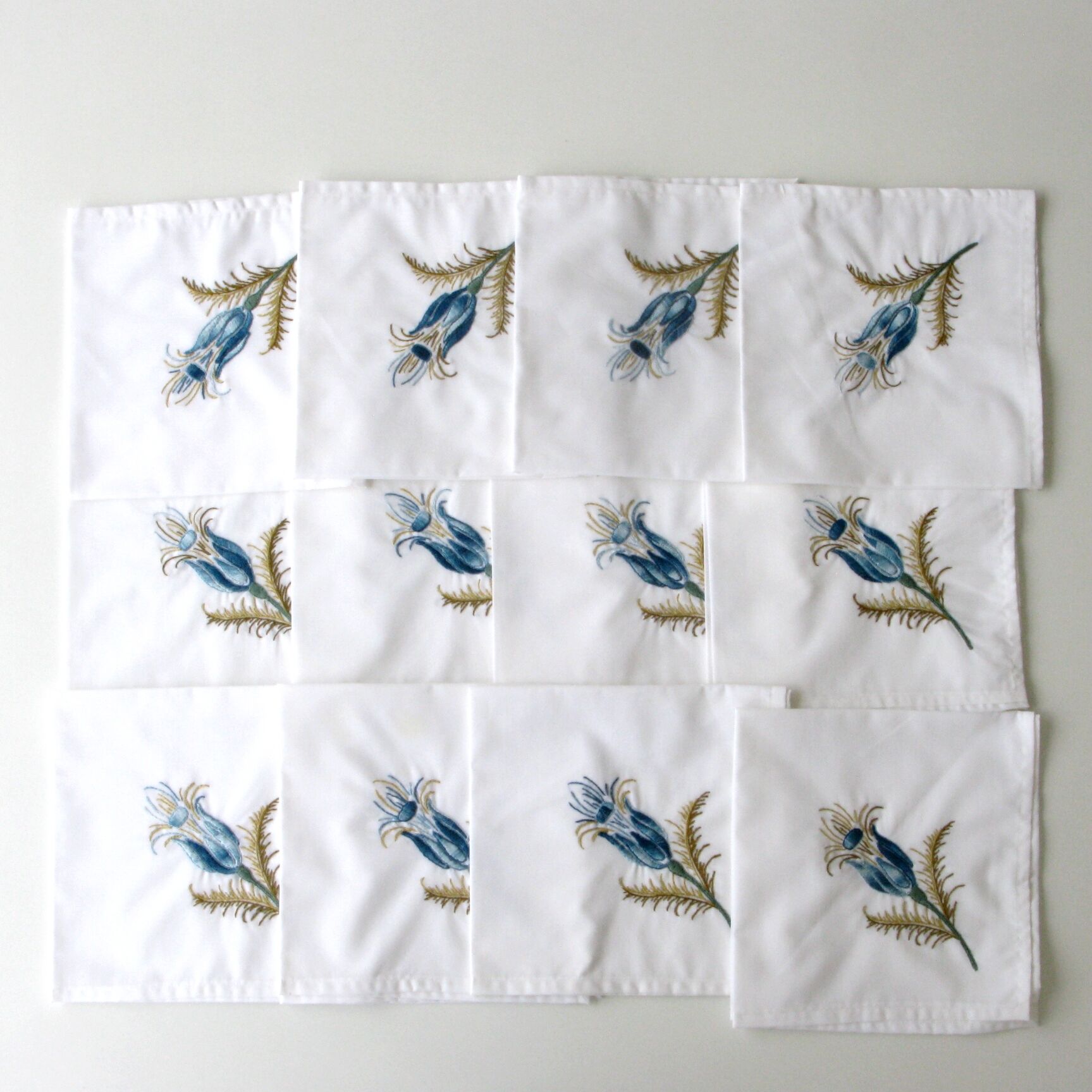 Antique rectangular hand-embroidered tablecloth decorated with thistle and 12 towels