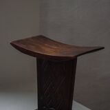 Sculptural African stool in hardwood, curved seat and architectural base, 1970s.