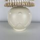 Vintage ceramic lamp with wicker and cotton shade.