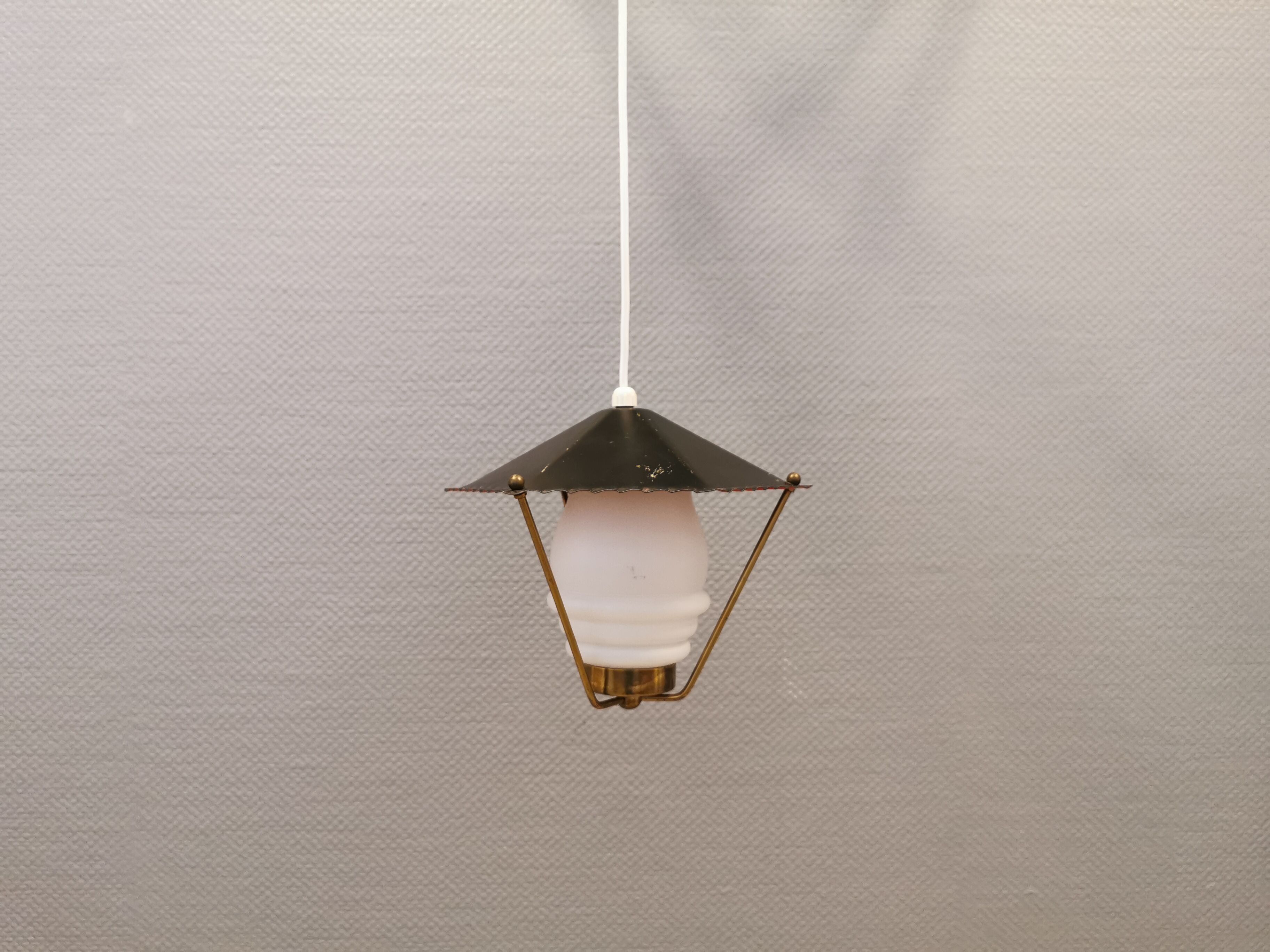 Danish hanging lamp from the 50-60s, made of brass, metal and with milky white glass shade.