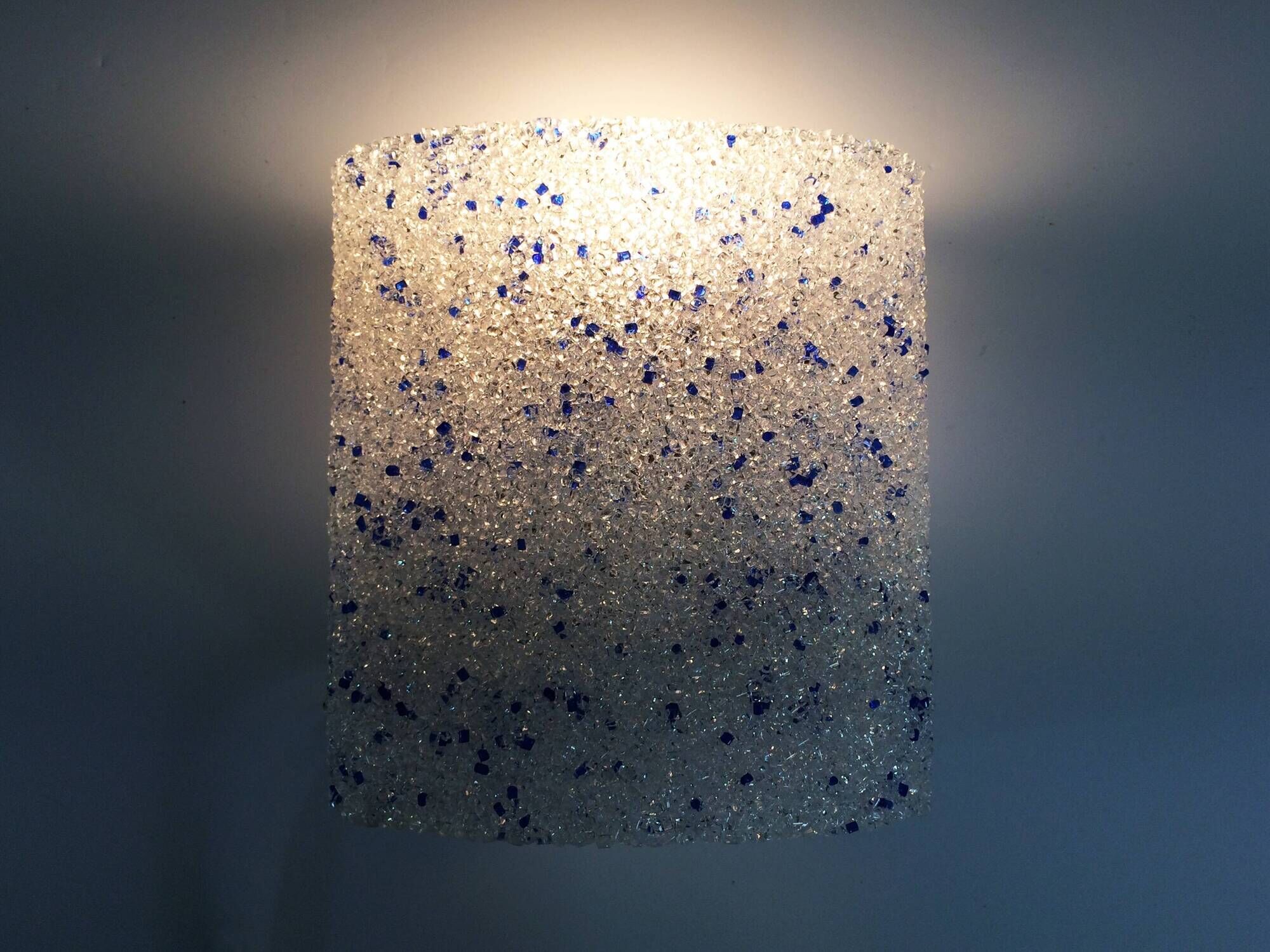 Pair of vintage wall sconces in transparent and wavy blue perspex. Year 60