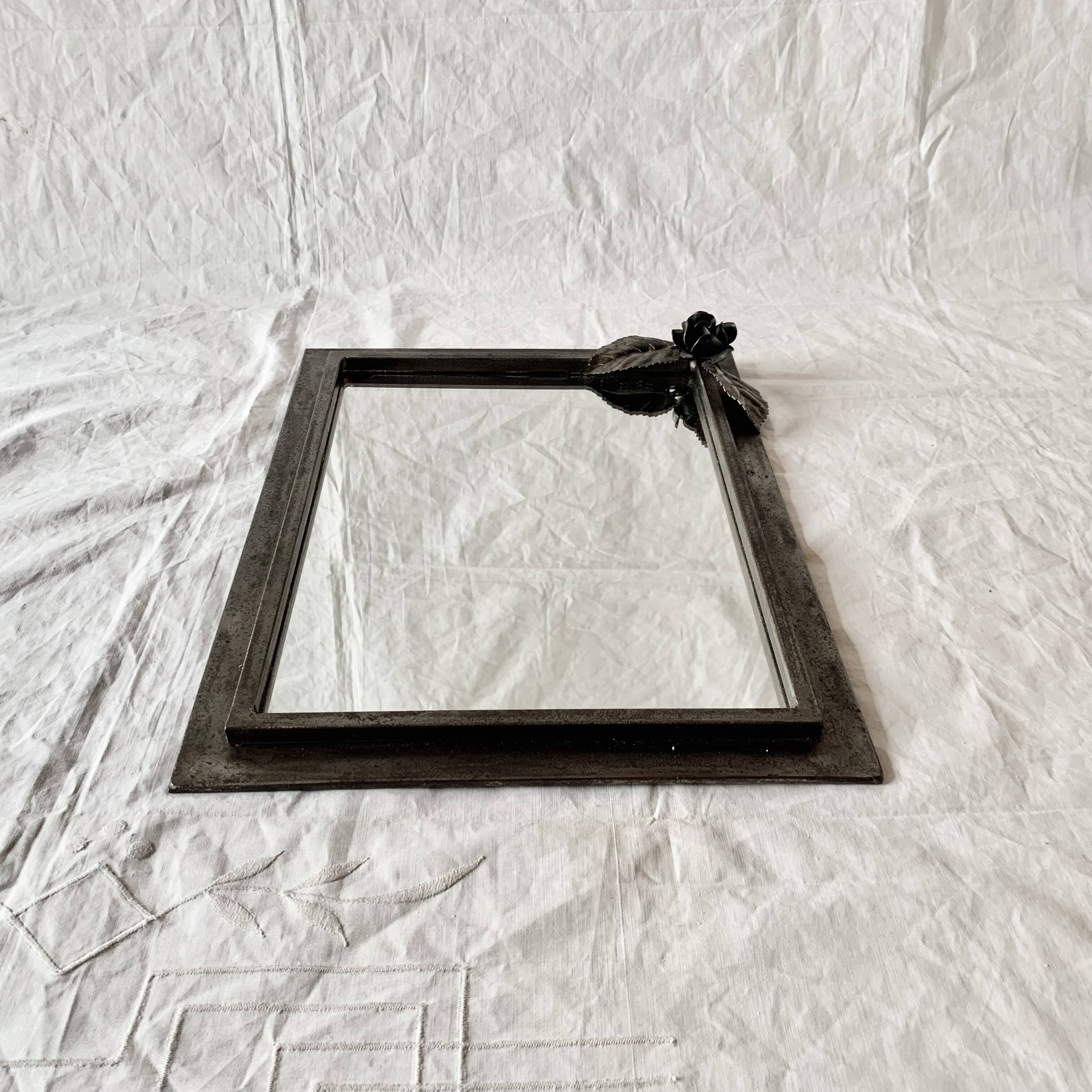 Vintage wall mirror in varnished steel decorated with a rose in relief