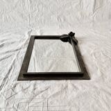 Vintage wall mirror in varnished steel decorated with a rose in relief