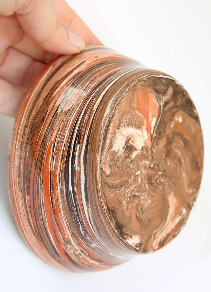 Terracotta cup in mixed earth