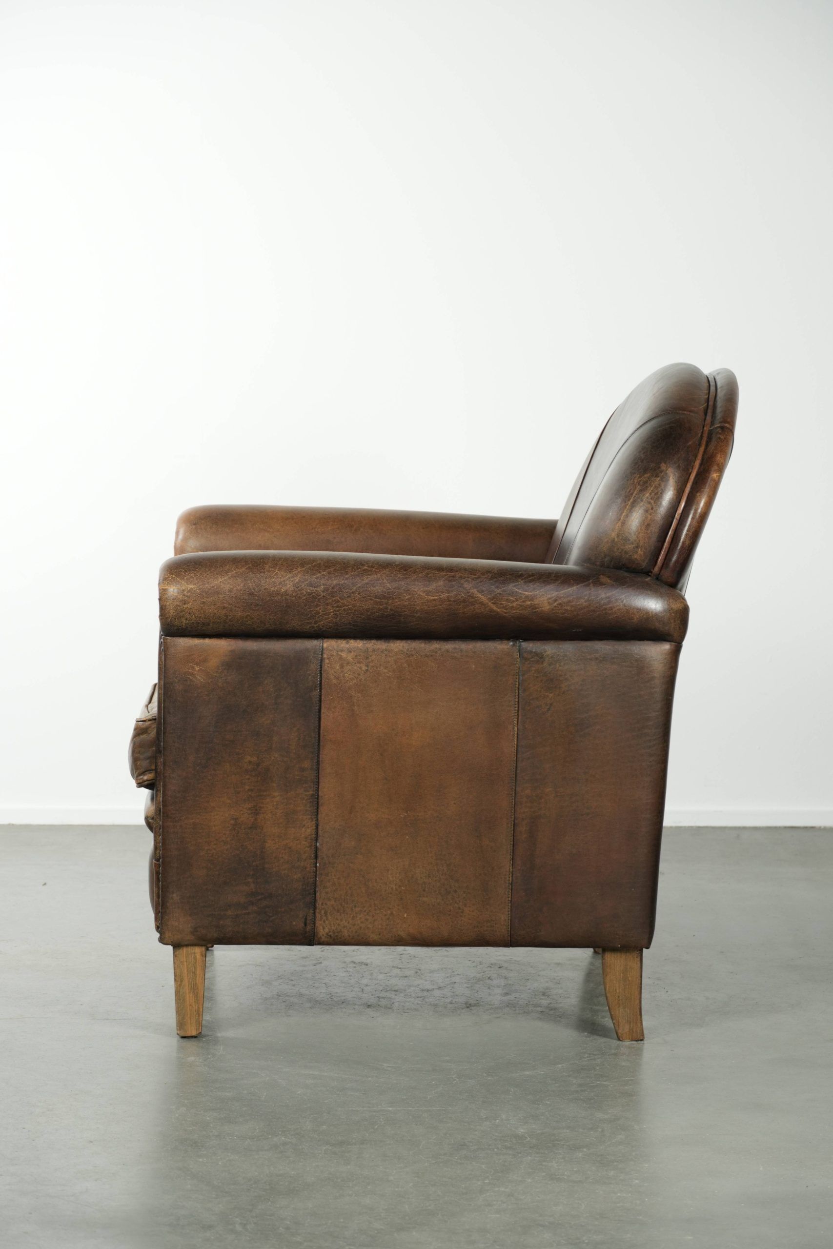 Characterful sheepskin design armchair with beautiful patina