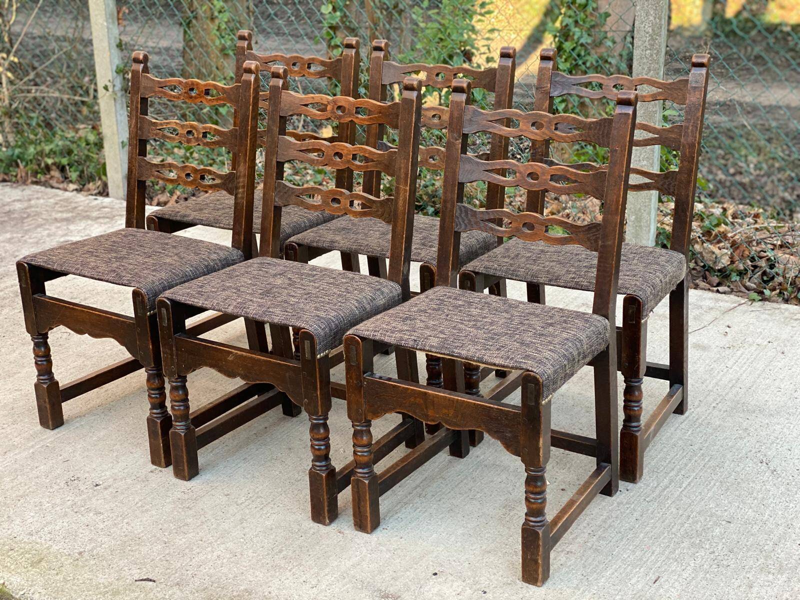 6 solid wood dining chairs with grey woven wool seats.